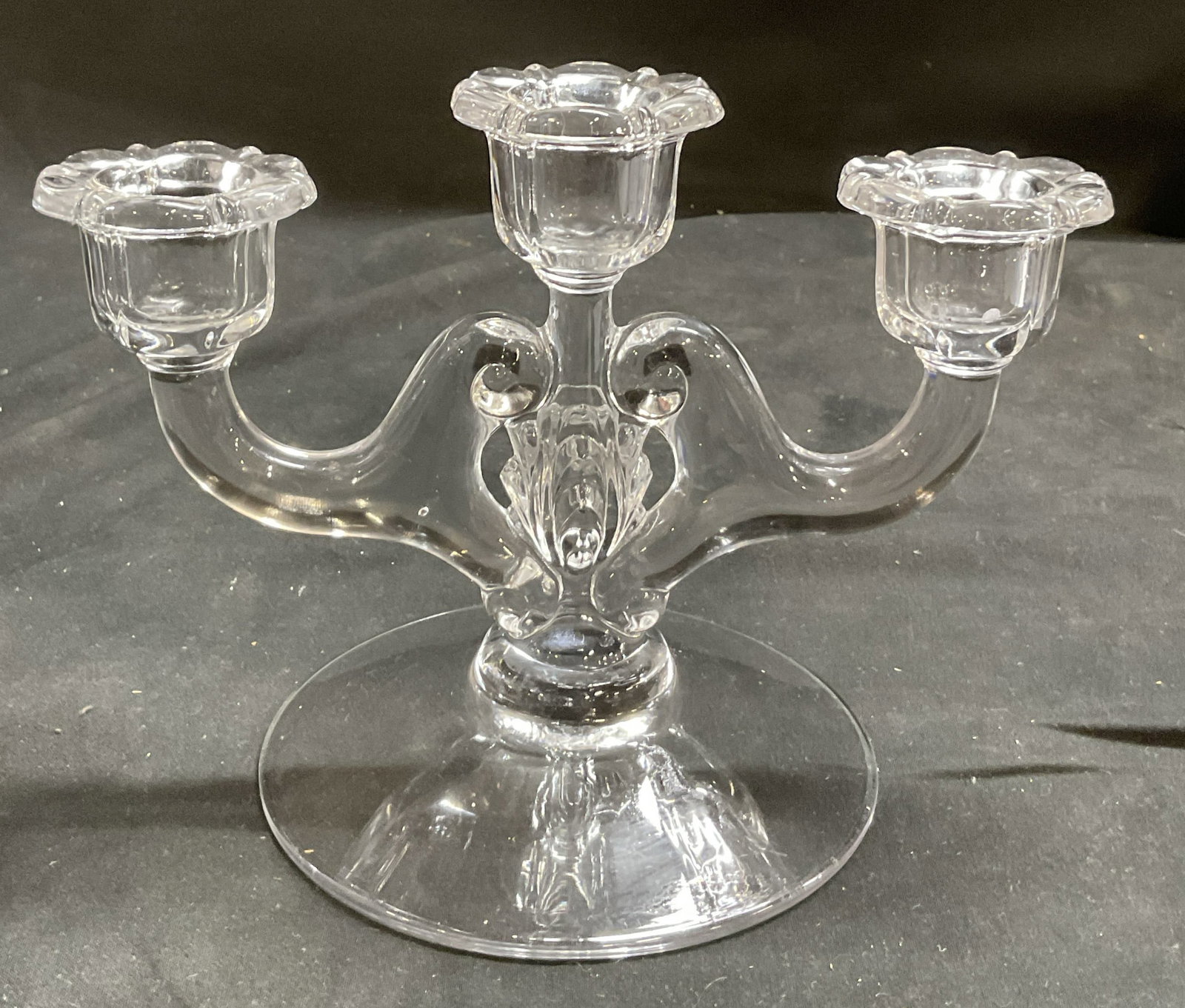 VTG Clear Glass Triple Candlestick Holders: Vintage Clear Glass Triple Candlestick Holders. Scrolled design. Scalloped rims. Condition consistent with age and exposure. Measures approx 6in H x 8in L. vintage candlestick holders, glassware, clea