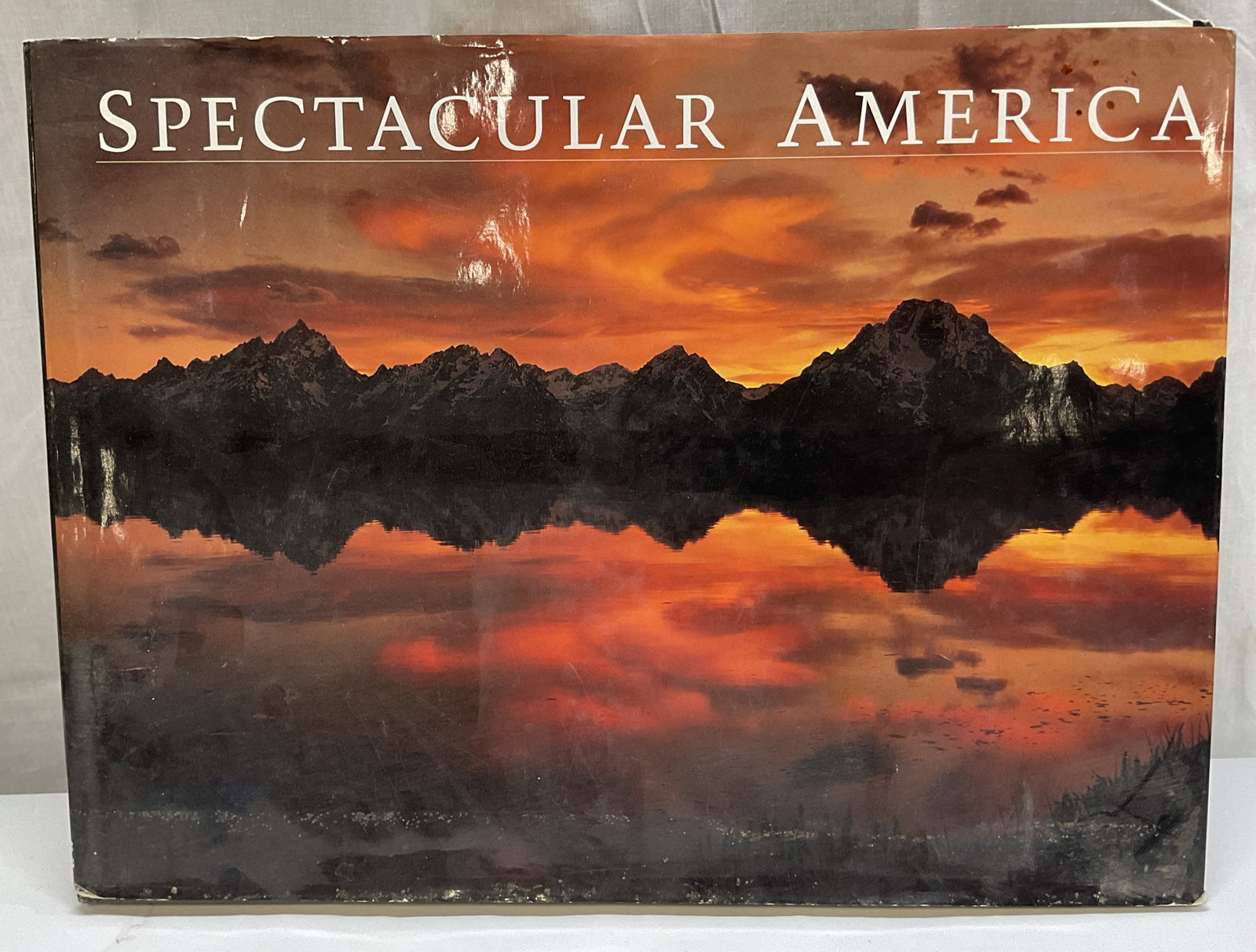 1994 Spectacular America Illustrated Book+: Spectacular America. Edited by Dana Levy and Letitia Burns OConnor. Photography by Tom Bean, Carr Clifton, Liz Hymans, and more. Published by Beaux Arts Editions. Hard cover book with illustrated cove