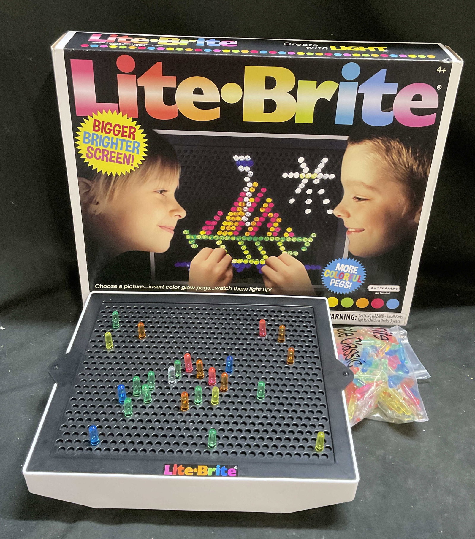 Hasbro & Basic Fun Vintage-Style Lite Brite Toy: Hasbro and Basic Fun Vintage-Style Lite Brite Ultimate Classic Toy. Designed with bigger and brighter screen and 4 different light modes. Condition consistent with exposure. Measures approx 11in H x 1