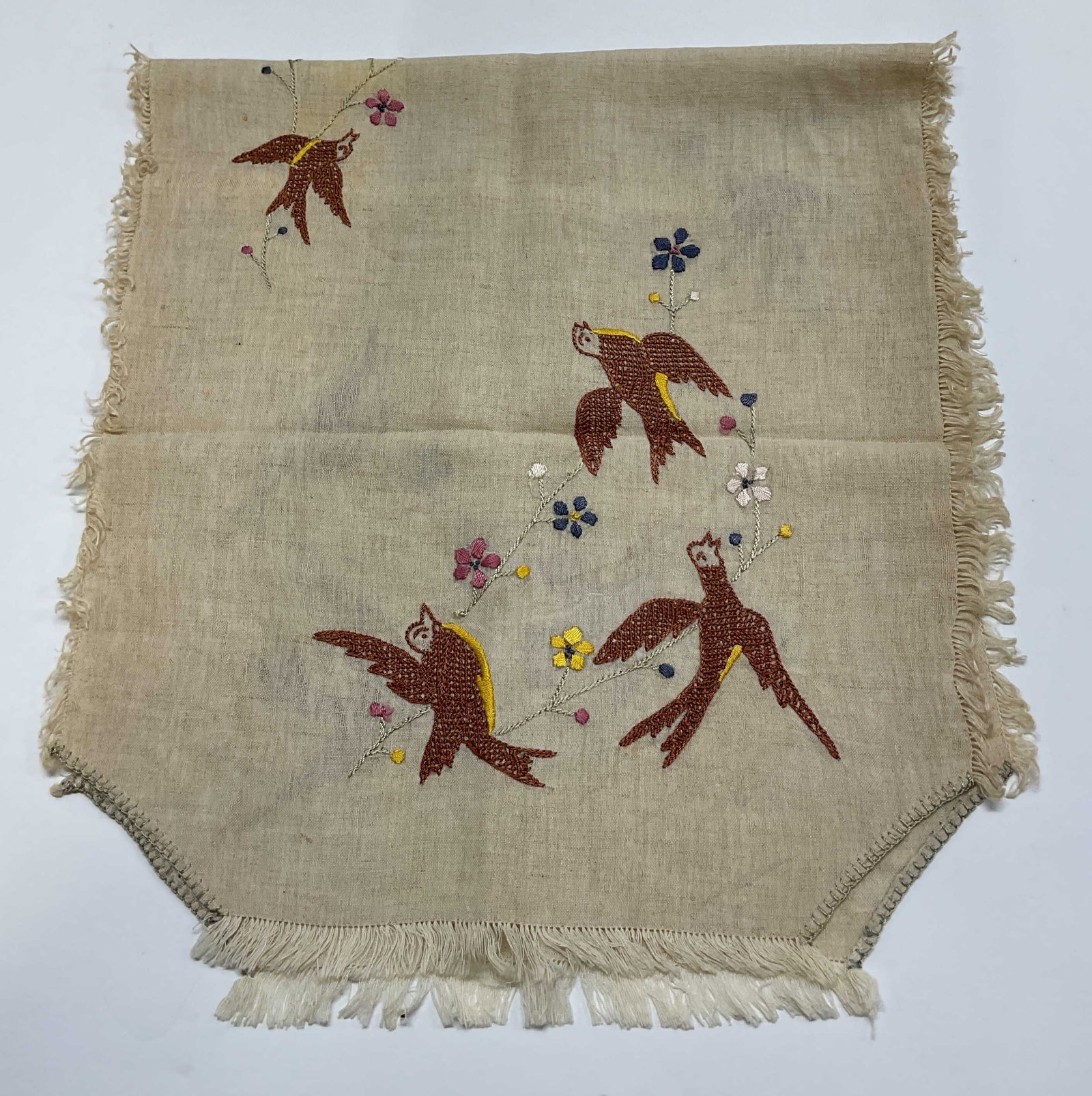 Vtg Cream Embroidered Fringed Linen Table Runner: Vintage cream embroidered fringed linen table runner. Fringed trim. Embroidered floral and bird motifs. Varying colors. Unique corners. Measures approx 15 x 33 inches. Blemishes. Table runner, linens,