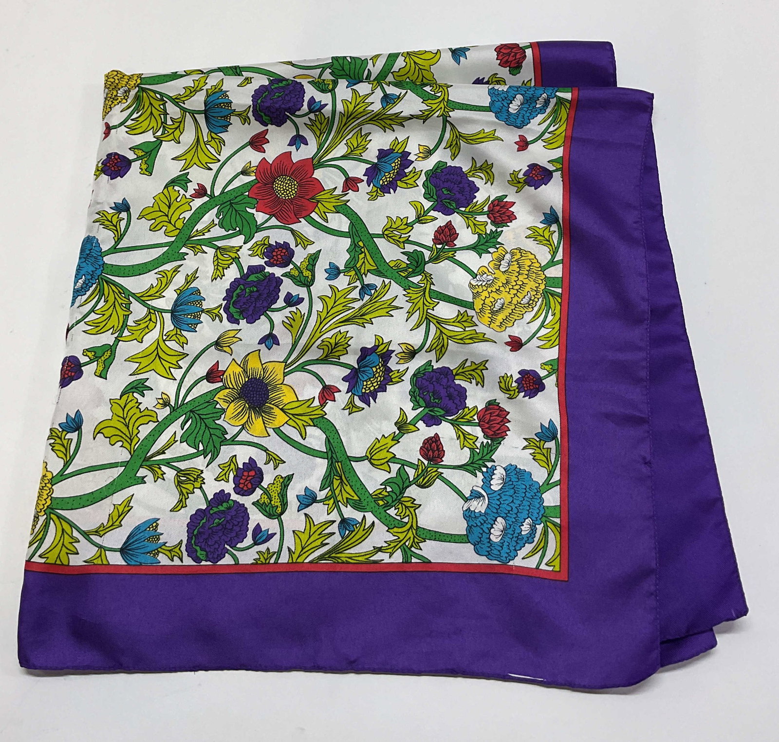 Vintage Floral Purple Silk Scarf: Vintage floral purple silk scarf. Purple and red border. Floral motifs in varying colors. Measures approx 30.5 x 30.5 inches. Some small holes in fabric and blemishes. Silk scarf, scarf, wearables,