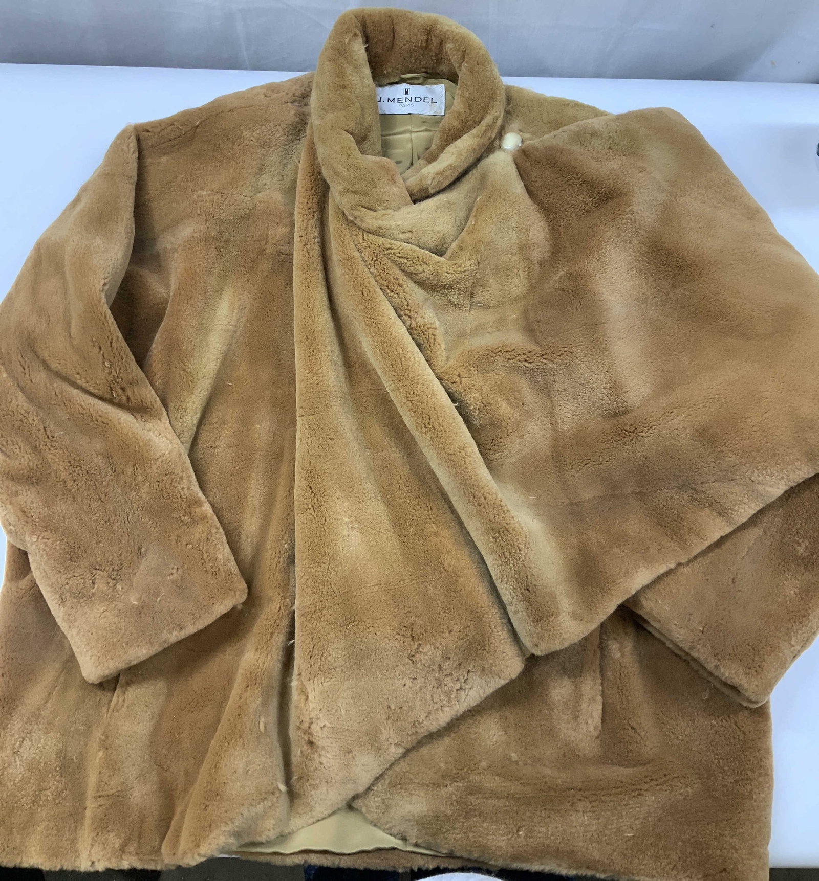 Vntg J.Mendel fur wrap coat, France: Vintage J. Mendel fur wrap coat. J. Mendel is a luxury fashion house based in France known for its furs. The item features a rich camel color palette. It has a dense highly plush texture, the style