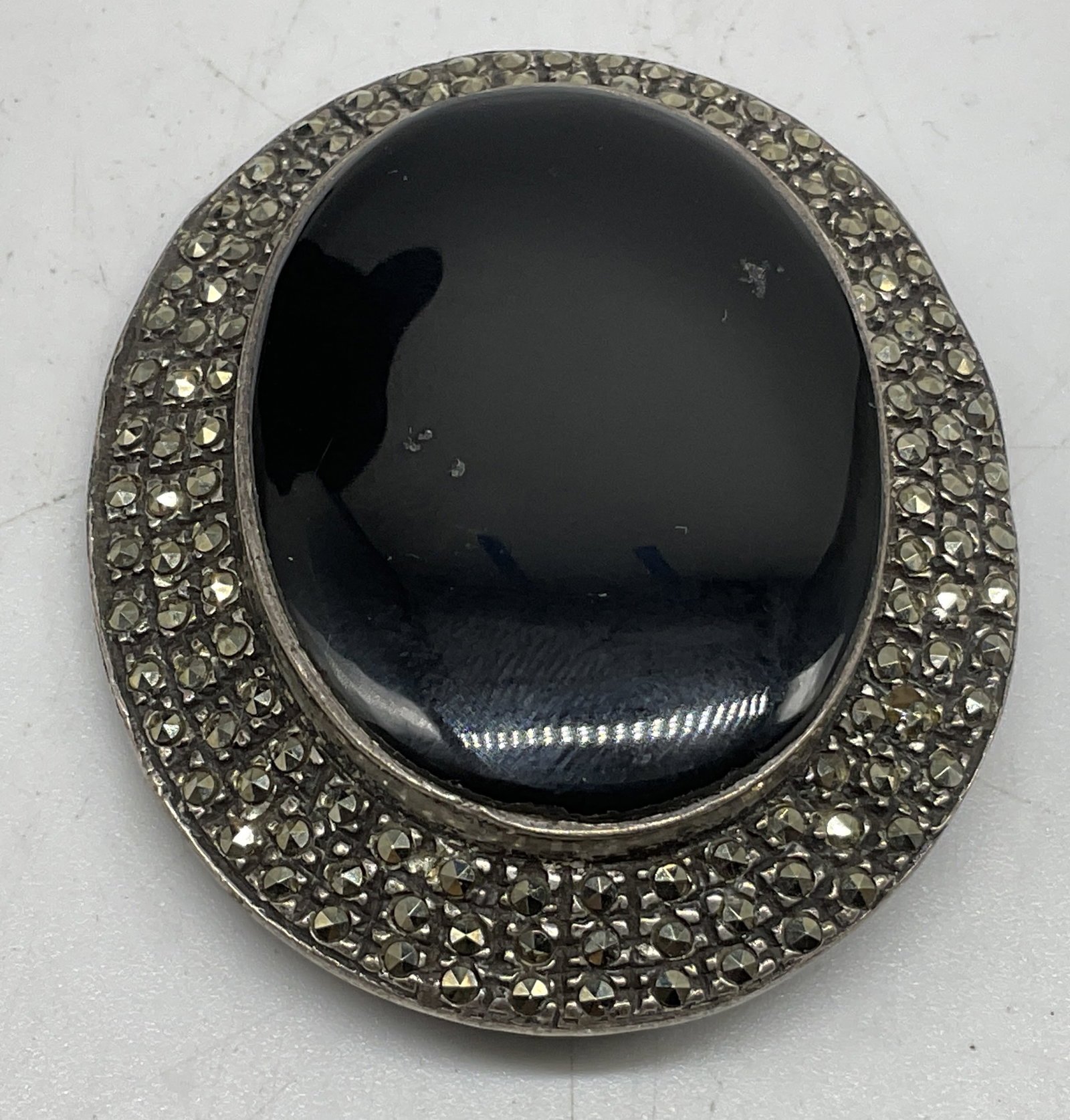 Vtg Art Deco Sty Onyx Sterling Brooch THAI: Vintage Art Deco Style Sterling Silver Brooch. Marked 925. Thailand. Polished black onyx cabochon center. Framed by pave-set glittering marcasite stones. Tested with Presidium Gem Tester II.