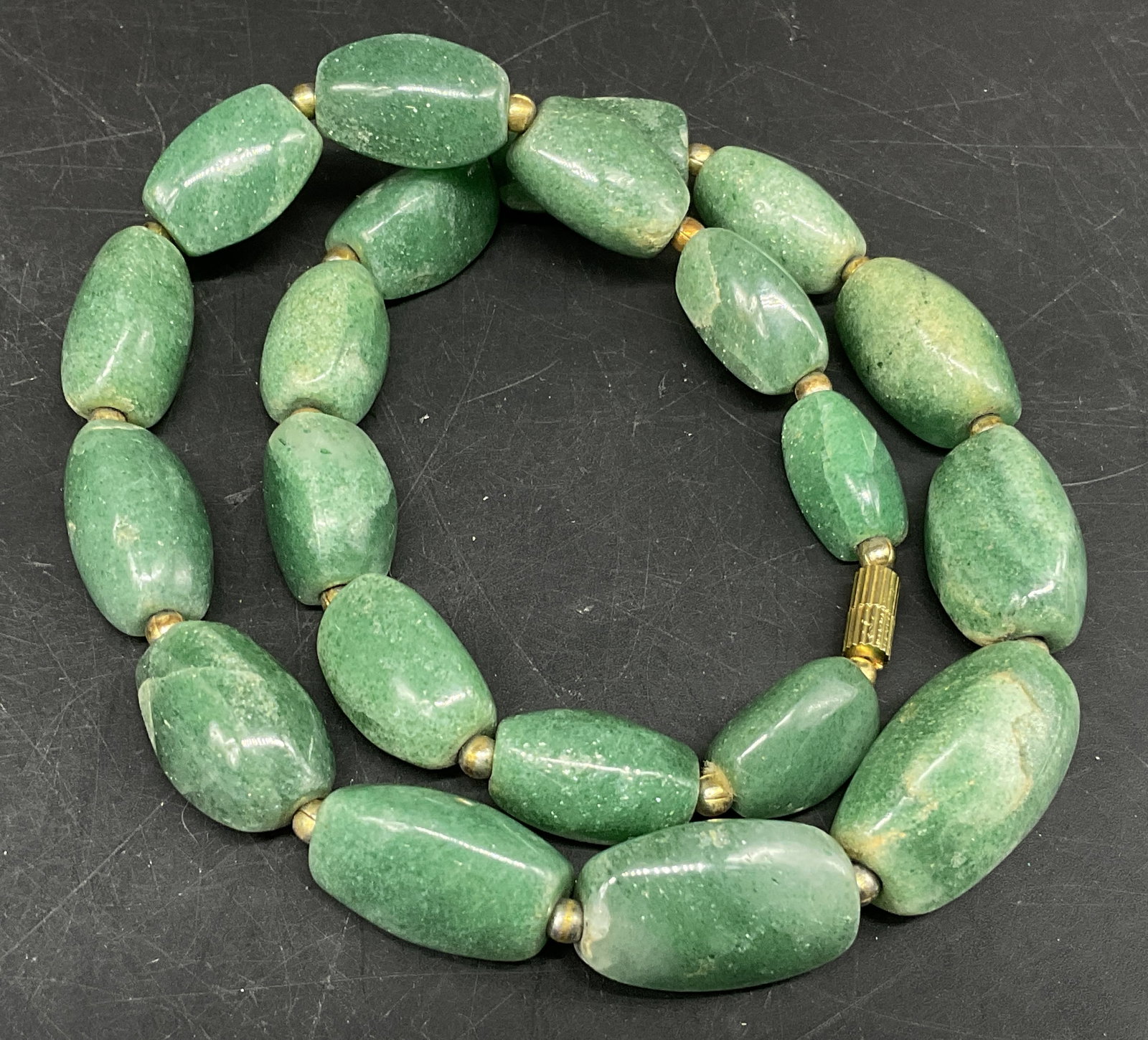 Vtg Barrel-Cut Aventurine Quartz Necklace: Vintage Circa 1970s Barrel-Cut Green Semi-Precious Gemstone Beaded Necklace. Appears to be aventurine quartz. Shimmering mica inclusions. Tested with Presidium Gem Tester II. Gold-Toned spacer beads.