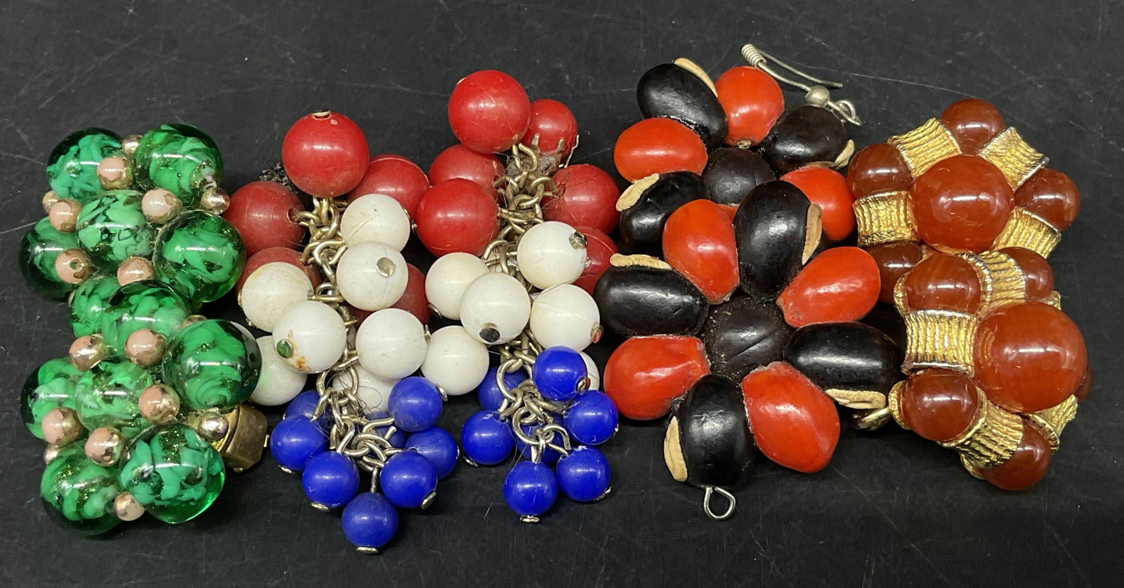 Lt4 Pairs Vtg Cluster & Dangle Earrings: 4 Pairs of Vintage Cluster and Dangle Earrings. Textured green glass beaded cluster earrings. Red, white, and blue resin bead dangle earrings. Black and red natural seed pod floral dangle earrings.