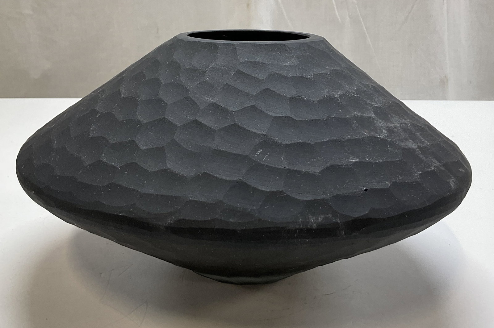 Cyan Design Glass Round Lava Vase: Cyan Design glass round lava vase. Intricate honeycomb pattern overlay. Textured surface. Round body with small opening. Deep black finish. Measures ht approx 5.5 inches diam approx 12 inches. Surface