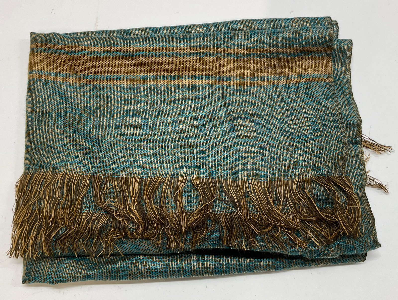 Hand Made Woven Cotton Fringed Scarf Ecuador: Hand made woven cotton fringed scarf. Tag reads Artesainas Tahuantinsuyo hand made in Ecuador 100% cotton. Fringed trim. Green and yellow geometric pattern. Measures approx 24 x 66 inches. Wear