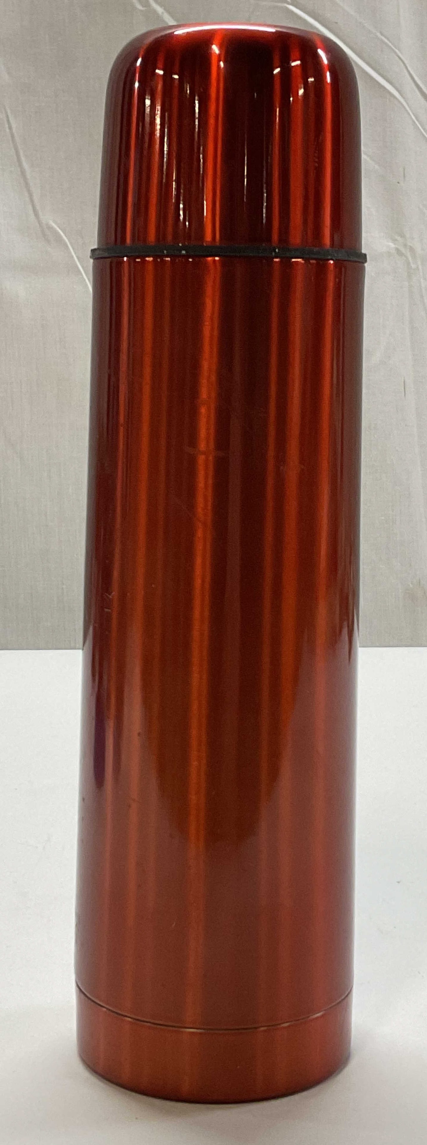 Stainless Steel Bullet Style Vacuum Flask: Stainless steel bullet style vacuum flask. Orange red color. Tall slender bullet design. Matching screw on cap. Measures ht approx 10 inches diam approx 2.5 inches. Scratching and surface wear.