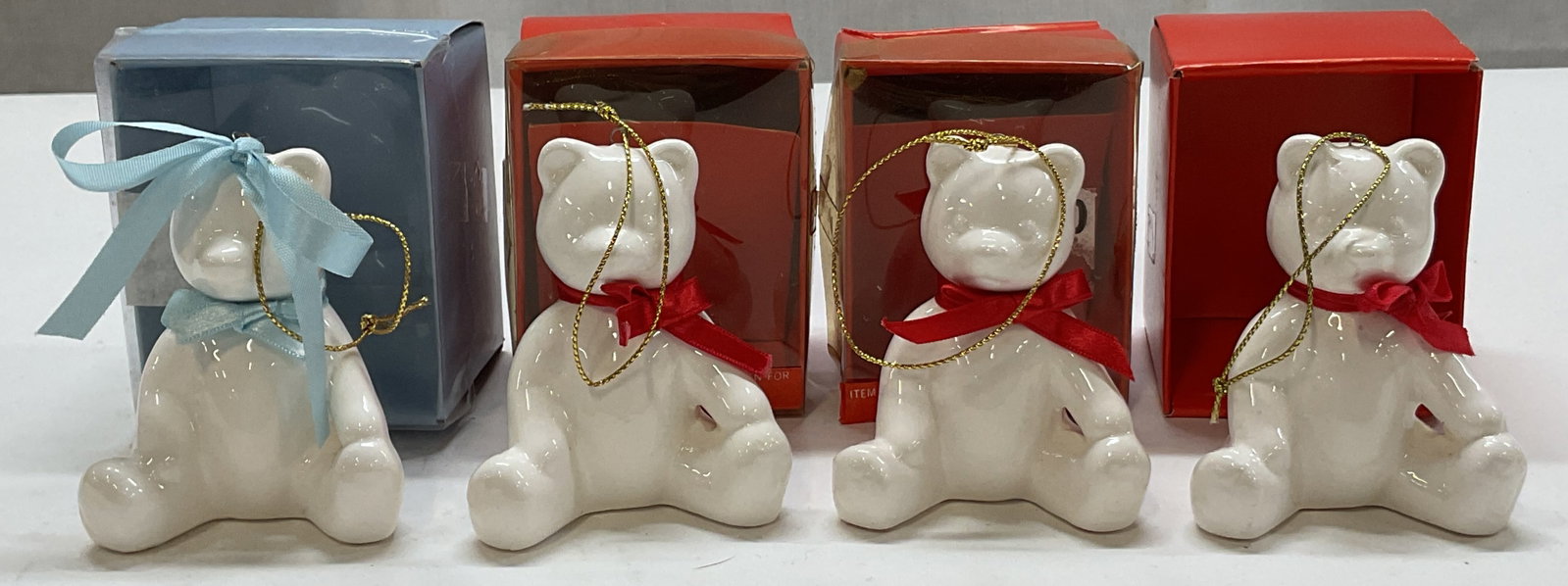 Lot 4 Nantucket White Ceramic Bear Ornaments W Box: Lot of 4 Nantucket white ceramic bear ornaments. Comes in original boxes. Made for Nantucket Distributing. Teddy Bear figures with red and blue bows. Gold toned string attached. Measures approx 2.5 x 