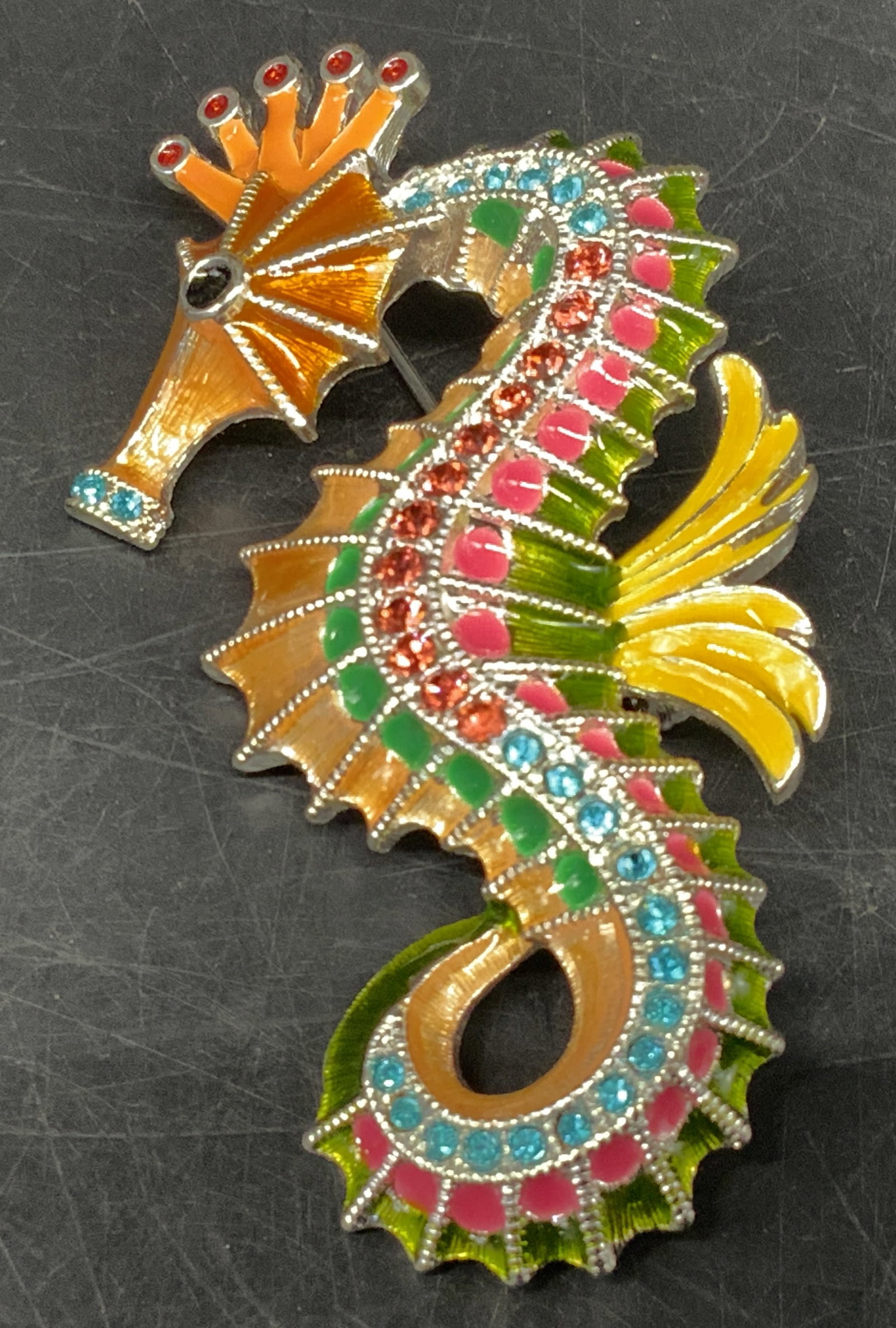 Pastel Multicolored Enamel Seahorse Brooch: Pastel Multicolored Enamel Seahorse Brooch. Pink and blue rhinestone accents. Silver-Toned backing and details. Condition consistent with age and exposure. Measures app 3in H x 1.5in L. vintage