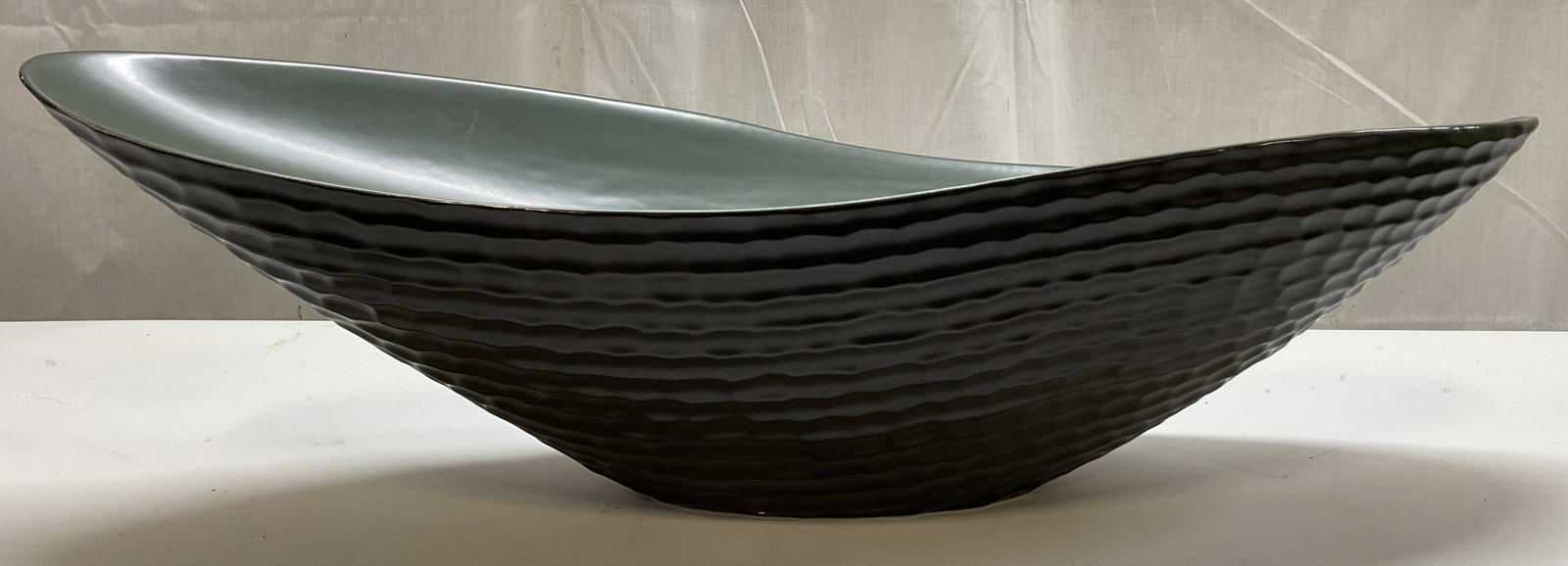 Global Views Big Bend Decorative Bowl Portugal: Global Views big bend ceramic decorative bowl. Marked on underside, reads Global Views Made In Portugal. Green interior. Textured black exterior. Long bent design with unique curved. Measures approx 6