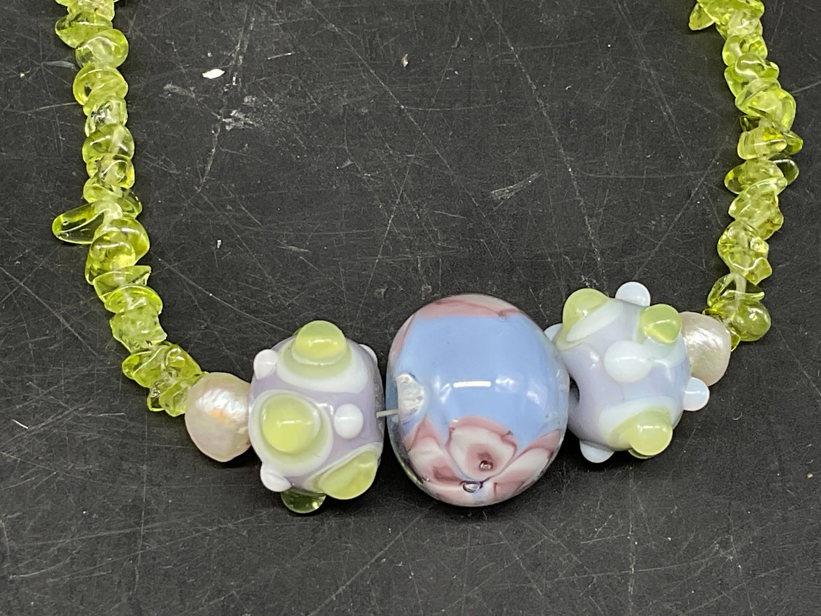 Gemstone Chip, Pearls and Glass Beaded Necklace: Beaded Necklace. Composed of irregular green gemstone chips, appears to be peridot. Tested with Presidium Gem Tester II. Cluster of natural pearls, floral glass bead, and spiked beads. Condition