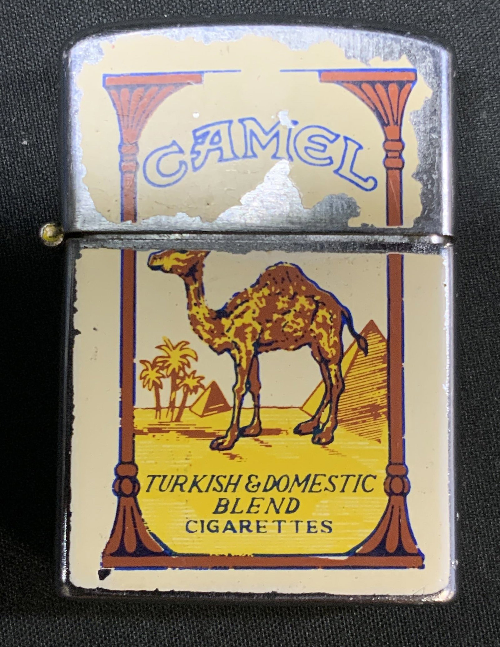 Vtg Krone Japan Camel Cigarette Emblem Lighter: Vintage Krone Japan Camel Cigarette promotional flip top Emblem Lighter. Double sided enamel painted panels of Camel package layout. Traditional fuel and flint wheel ignition system housed in chrome