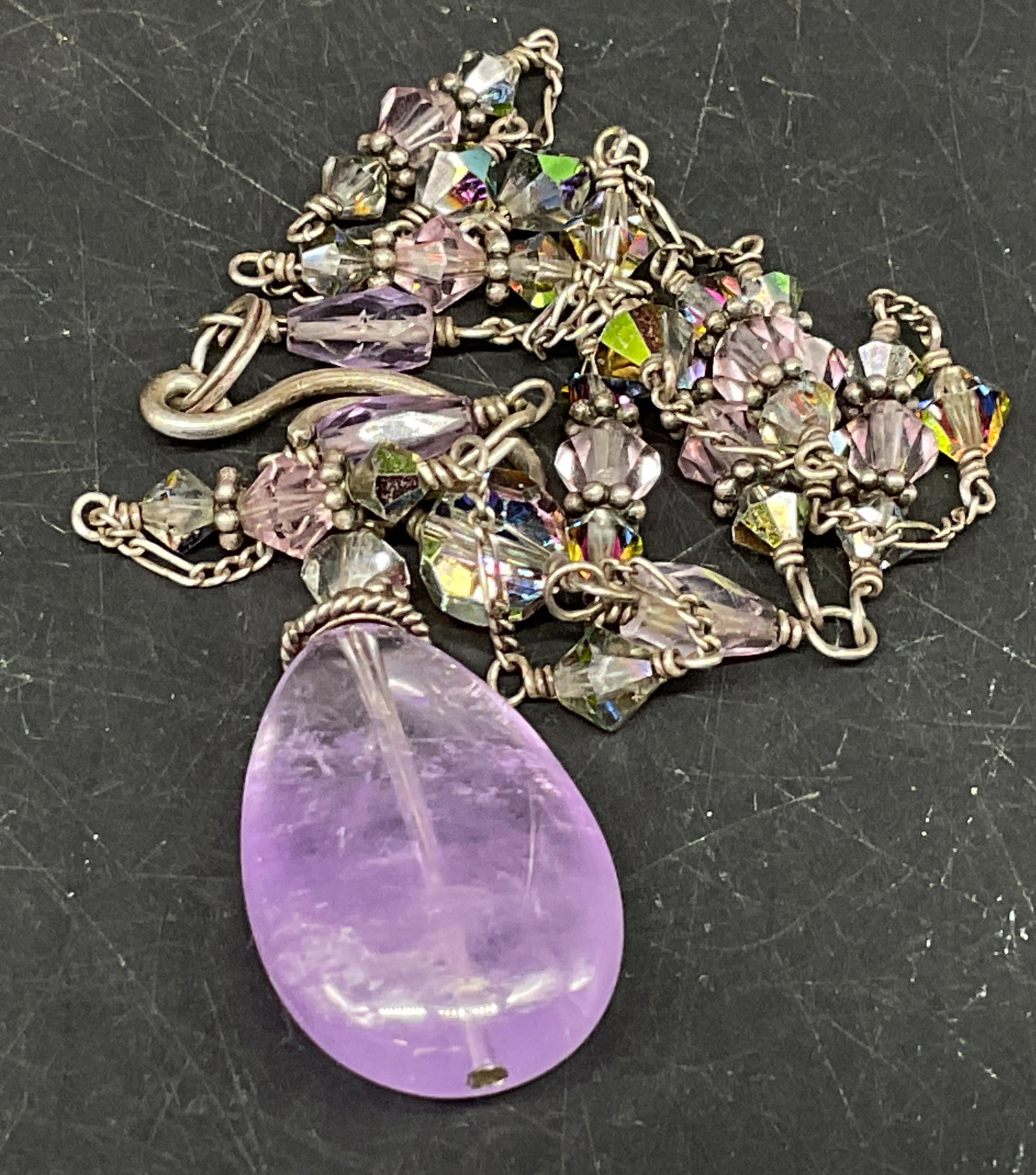 Amethyst Quartz Drop Station Beaded Necklace: Teardrop-Shaped Gemstone Drop Station Necklace. Appears to be amethyst quartz. Tested with Presidium Gem Tester II. Purple, clear, and metallic glass beads on silver-toned chain. Scratching on