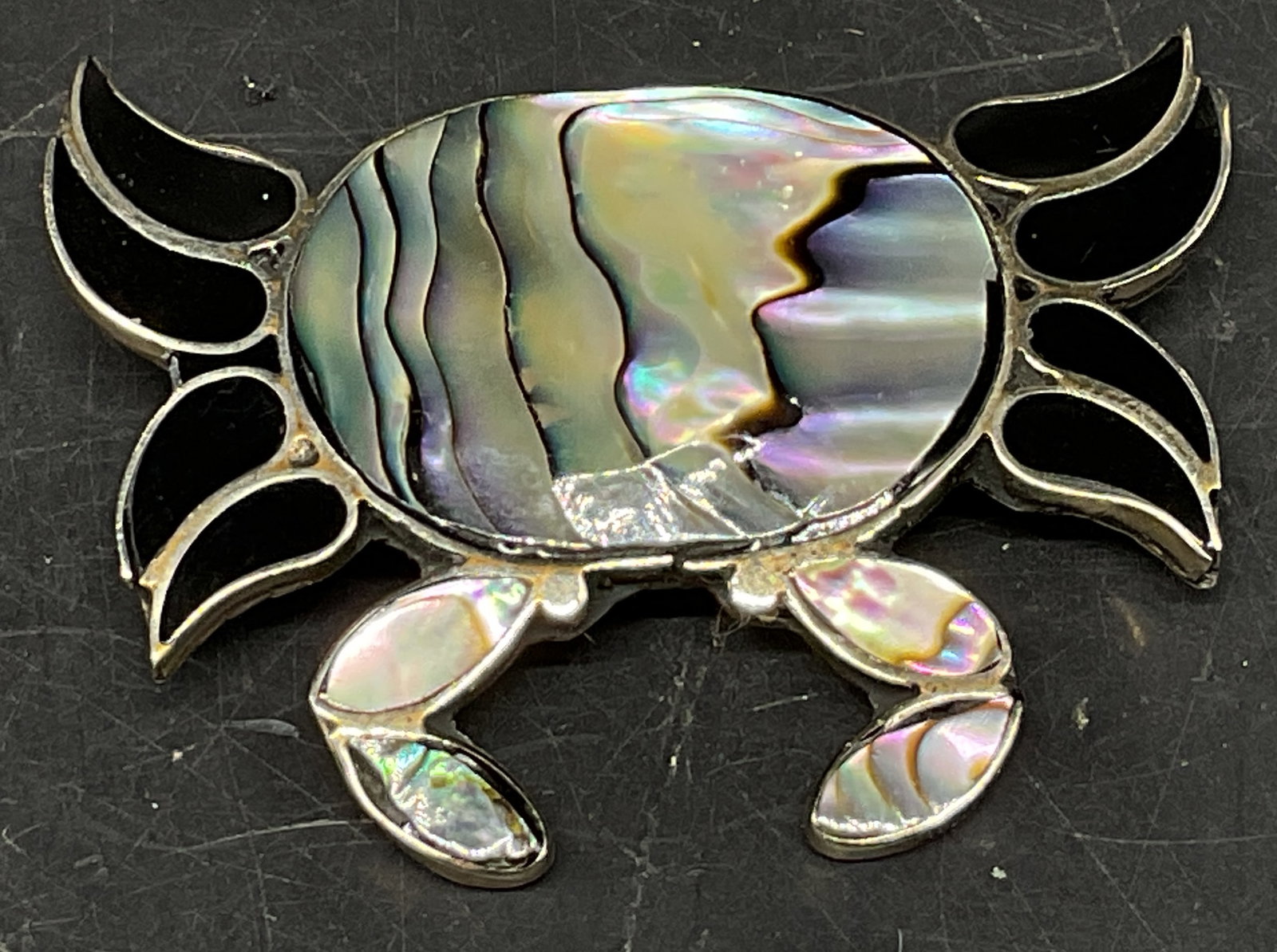 Vtg Abalone Shell & Onyx Crab Brooch Mexico: Vintage Alpaca Silver Crab Brooch. Iridescent Abalone Shell body and claws. Onyx legs. Mexico. Condition consistent with age and exposure. Measures app 1in H. vintage brooches, pins, alpaca silver,