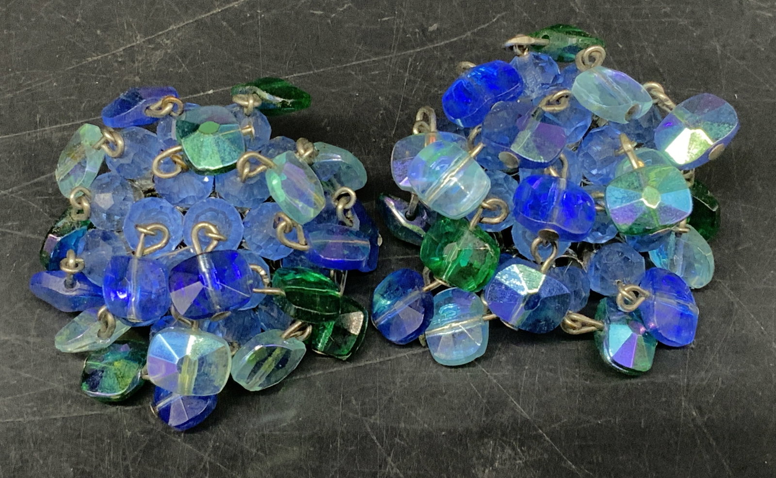 Vintage Vogue Beaded Cluster Clip-On Earrings: Vintage Circa 1950s-1960s American Vogue Jewelry Company Beaded Cluster Clip-On Earrings. Shimmering blue and green Aurora Borealis glass beads. Silver-Toned backing. Condition consistent with age