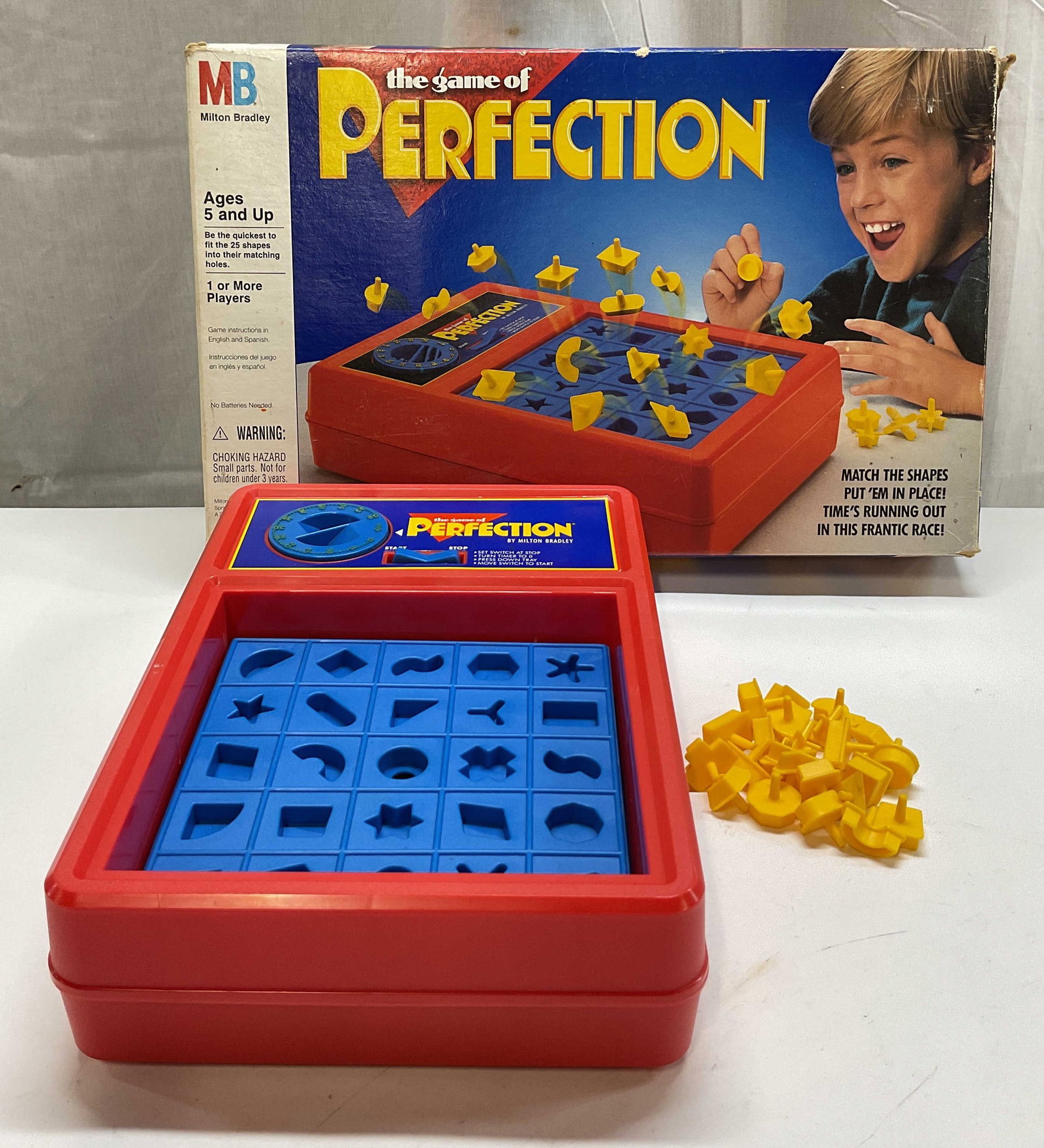 1990 Milton Bradley Game Of Perfection OrigBox USA: 1990 Milton Bradley The Game Of Perfection. Comes in original box. Made in USA. Includes game unit with timer and pop up tray and 23 geometric shapes. Unit features a built in storage compartment to s