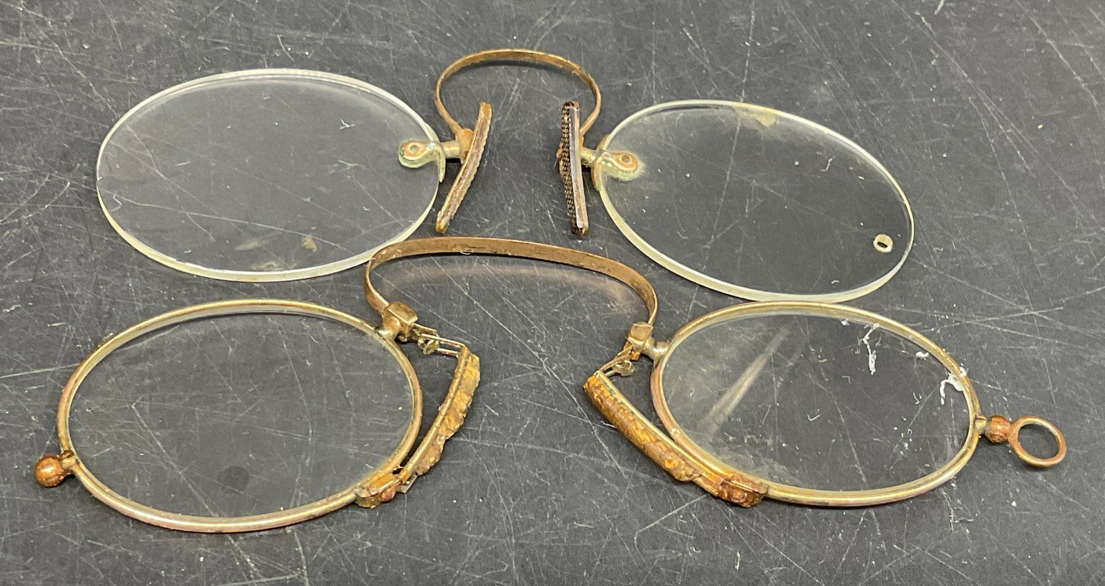 2Pair Antq GF Prince-Nez Eyeglasses: 2 Pairs of Antique Prince-Nez Eyeglasses. One rimless. One framed. Brass, possibly gold-filled. Tested with PuriTEST. No visible marks. Scratching and corrosion present. Measures app 1.5in H x 4.25in
