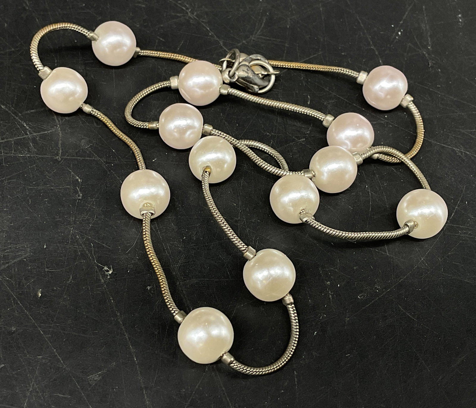 Pearl-Style Station Necklace: White Pearl-Style Station Necklace. Circular faux pearls on silver-toned chain. Tarnishing present. Measures app 17in L. necklaces, beads, faux pearls, jewelry, fashion accessories 8 J
