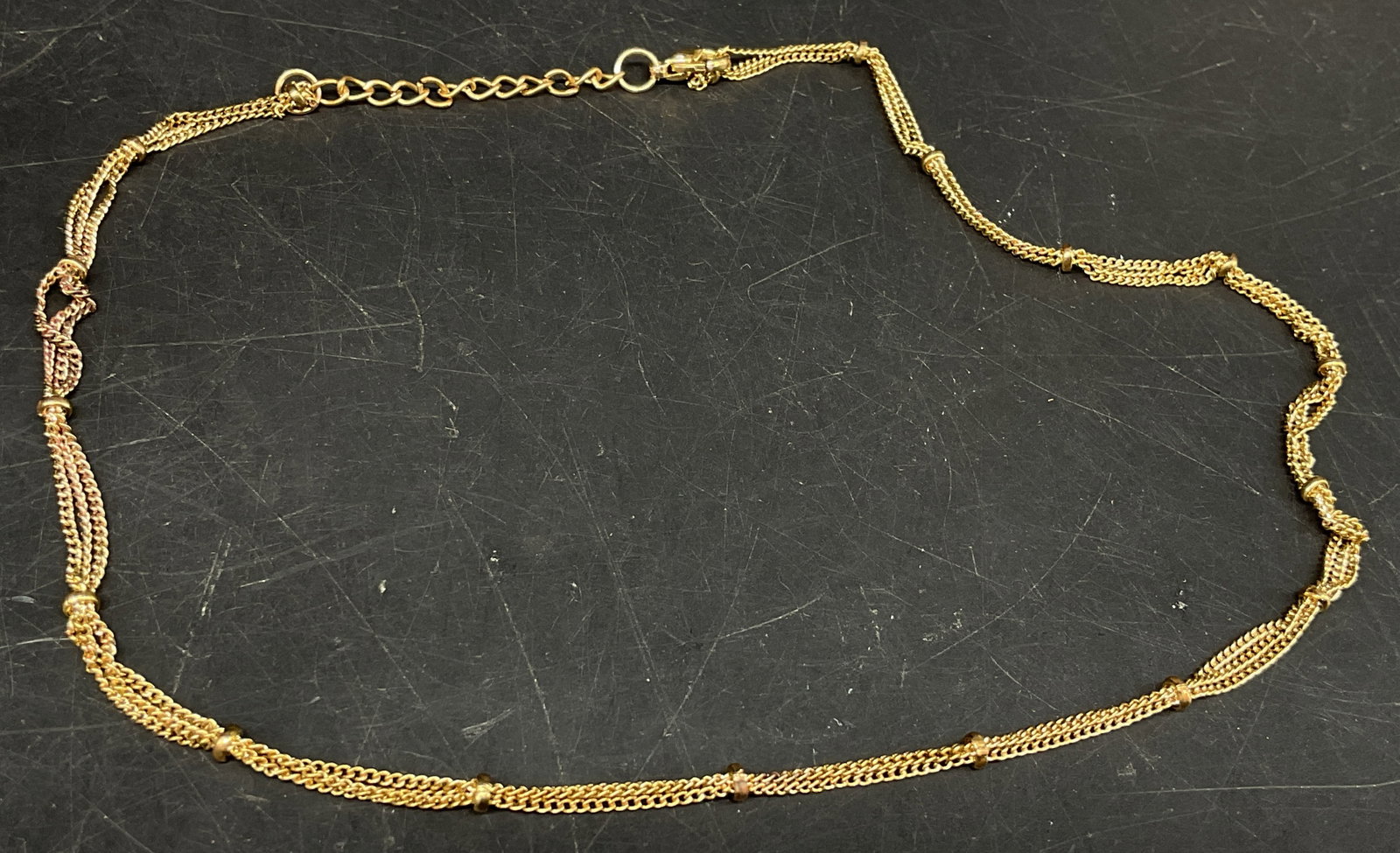 Vtg Multi-Strand Gold-Toned Liquid Chain Necklace: Vintage Multi-Strand Gold-Toned Liquid Chain Necklace. Possibly gold-plated. Tested with PuriTEST. Small gold-toned beads. May need new link where clasp hooks. Measures approx 14in across chain with