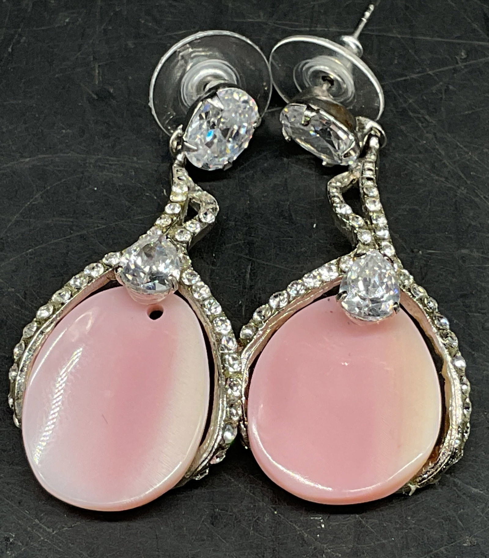 Signed Siman Tu Pink Conch Shell Earrings: Signed Siman Tu Earrings. Pink conch shell center in silver frame. Sparkling crystal accents. Condition consistent with age and exposure. Measures app 1.75in H. earrings, signed, Siman Tu,