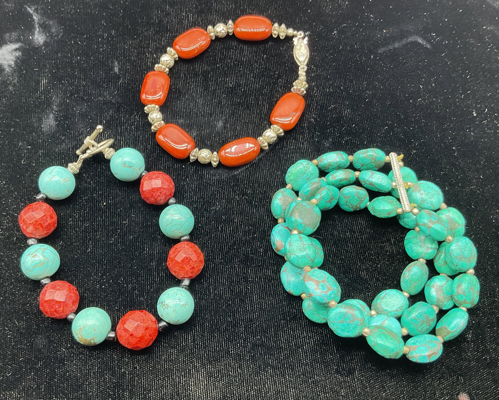 Lt3 Vtg Assort Turquoise & Glass Beaded Bracelets: Lot of 3 vintage assorted bracelets. Three layered turquoise stone beaded bracelet with silver toned spacers. Turquoise and red glass beaded bracelet with black spacers. Orange glass beaded bracelet