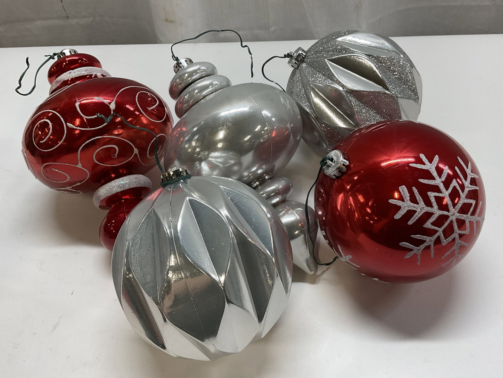 Merry Brite 5 Count Shatterproof Ornaments OB: Merry Brite 5 count shatterproof ornaments. Comes in original box. Box states it is a 6 count but there are only 5 in the box. Red and silver toned. Glitter accents with scroll and snowflake motifs.