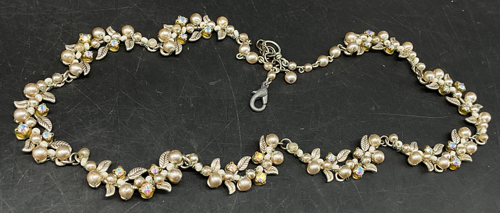 Vtg Pearl-Style&AB Rhinestone Collar Necklace: Vintage Collar Necklace. Silver-Toned leaf clusters accented with faux pearls and Aurora Borealis rhinestones. Some corrosion and coating loss on faux pearls. Measures approx 14.5in across beads with 