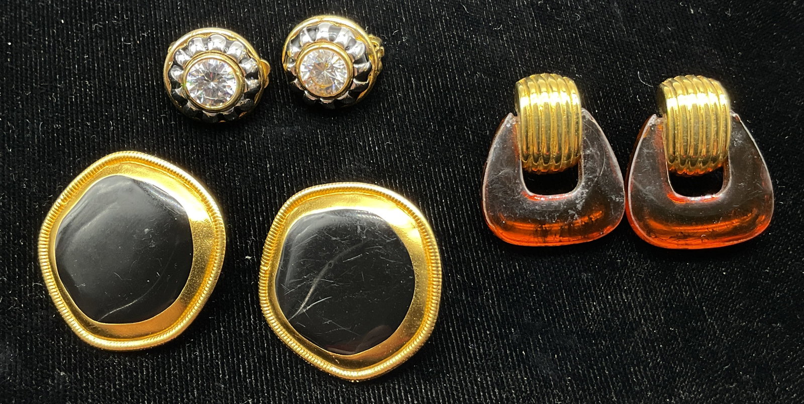 Lot 3 Vtg Assorted Enameled Earrings: Lot of 3 vintage assorted earrings. Amber style resin with gold toned ribbed design, backing closure. Rhinestone with silver toned and black enameled striped pattern with gold toned clip on closure. B
