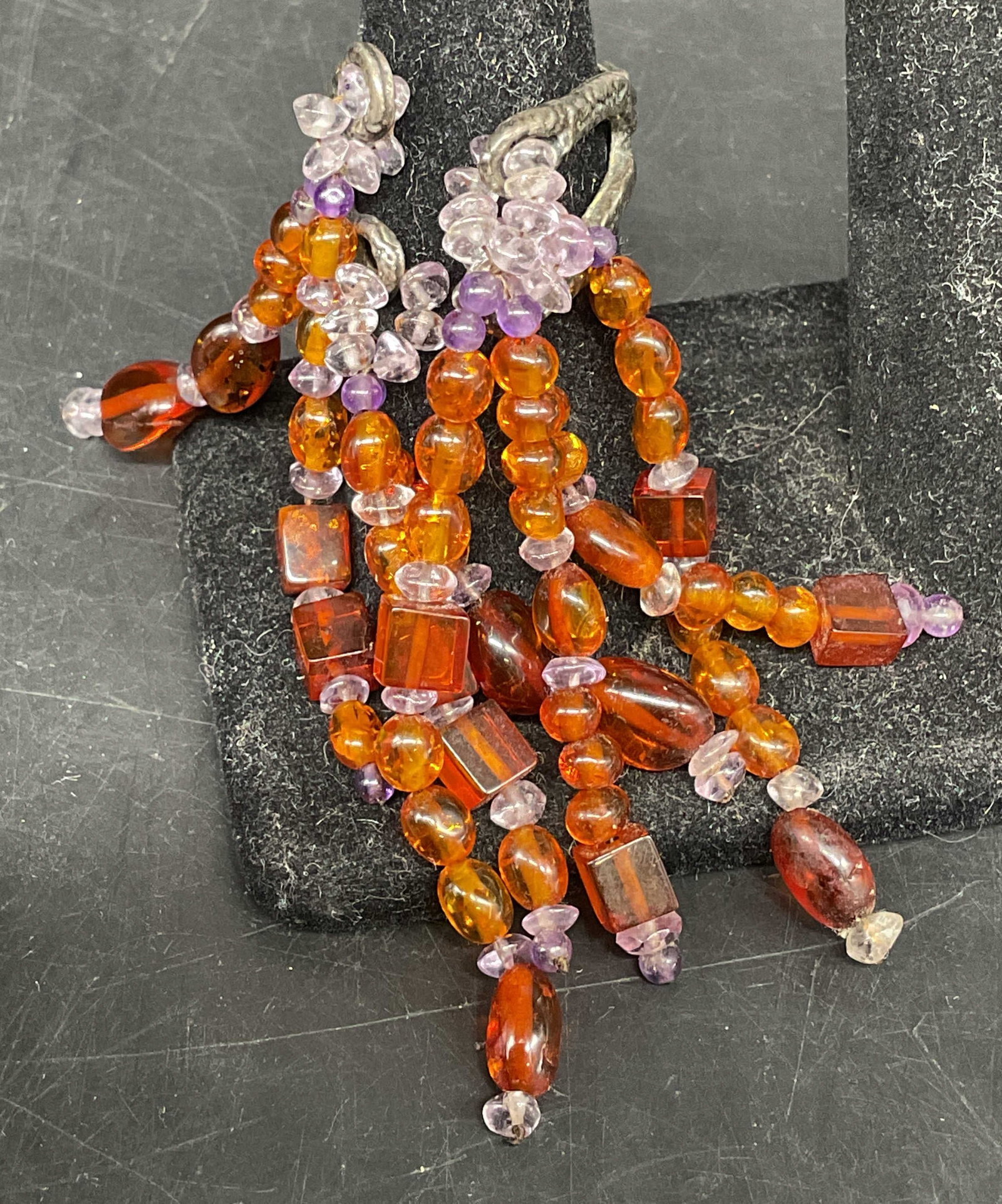 Silver-Toned Beaded Fringe Ring: Silver-Toned Ring. Cascading fringe of semi-precious gemstones, appears to be amber and amethyst chips. Tested with Presidium Gem Tester II. Condition consistent with age and exposure. Size 7.5.