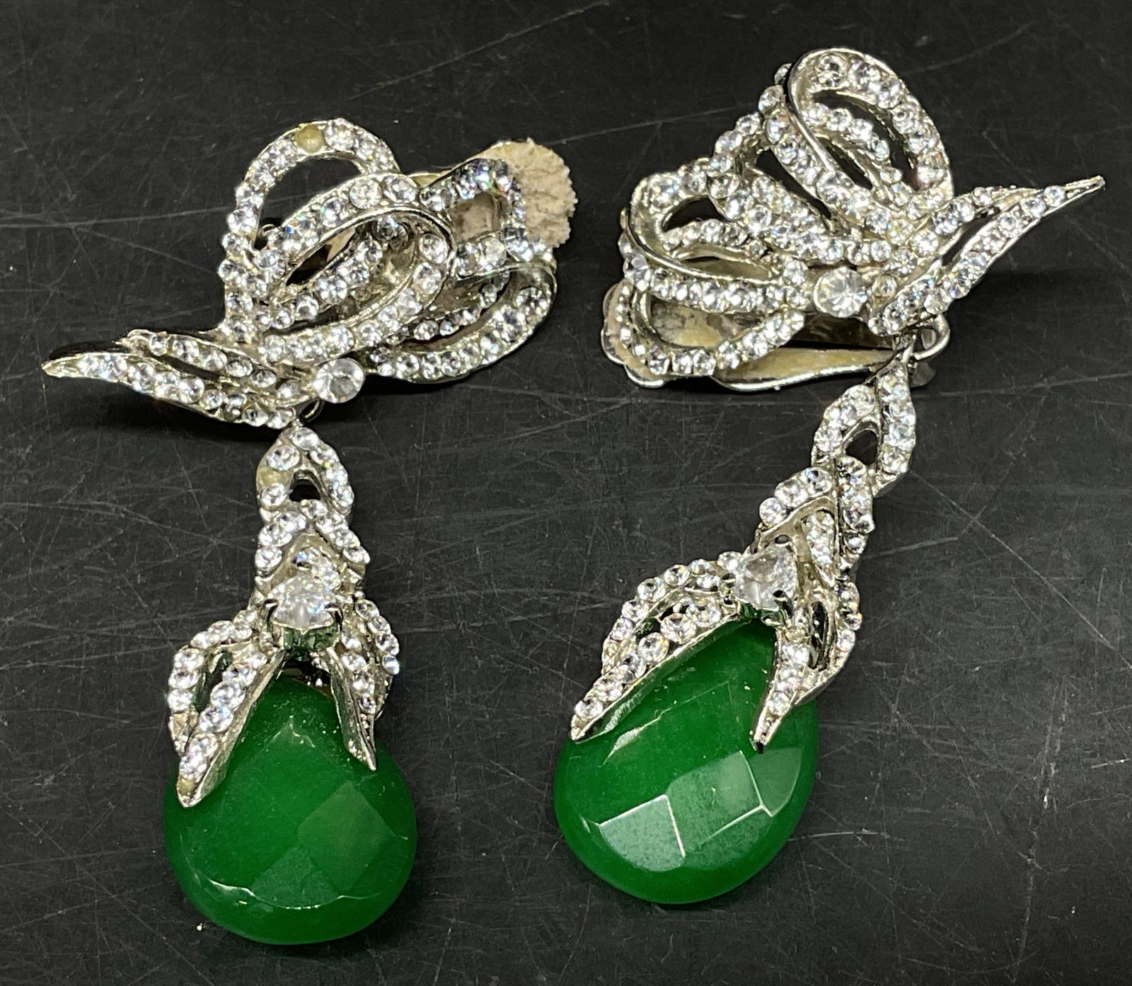 Vtg Sty Silver-Toned Butterfly Gemstone Earrings: Vintage Style Silver-Toned Clip-On Earrings. Butterfly design top pave-set with white rhinestones that cascade into a braided ribbon. Green teardrop shaped semi-precious gemstones drop, appears to be