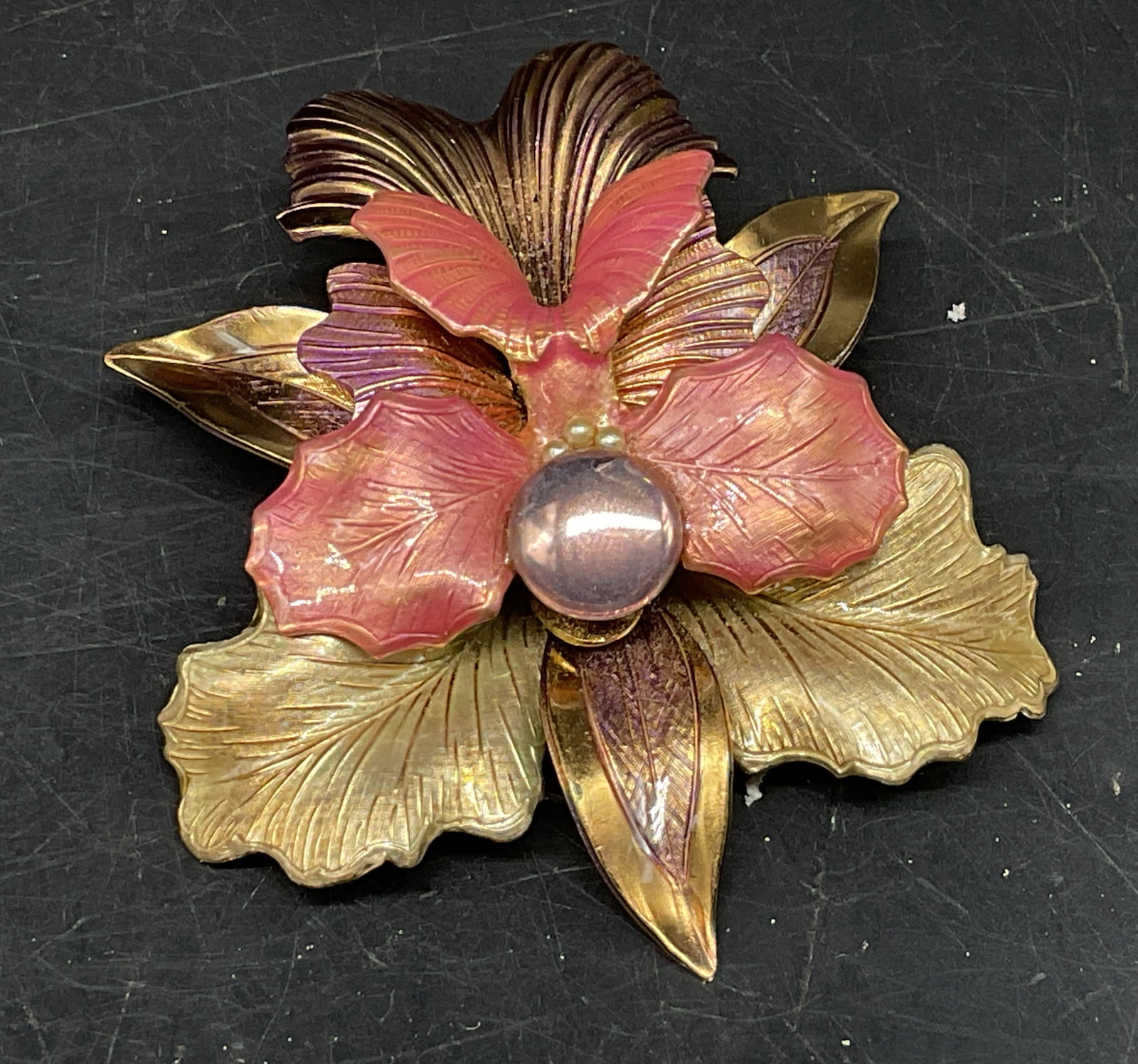 Vtg Gold-Toned Pink Enamel Orchid Flower Brooch: Vintage Textured Gold-Toned Orchid Flower Brooch. Pink enamel accents. Pink glass stone. Some coating loss present. Measures app 2in H. vintage brooches, pins, enamel, gold-toned, flowers, costume