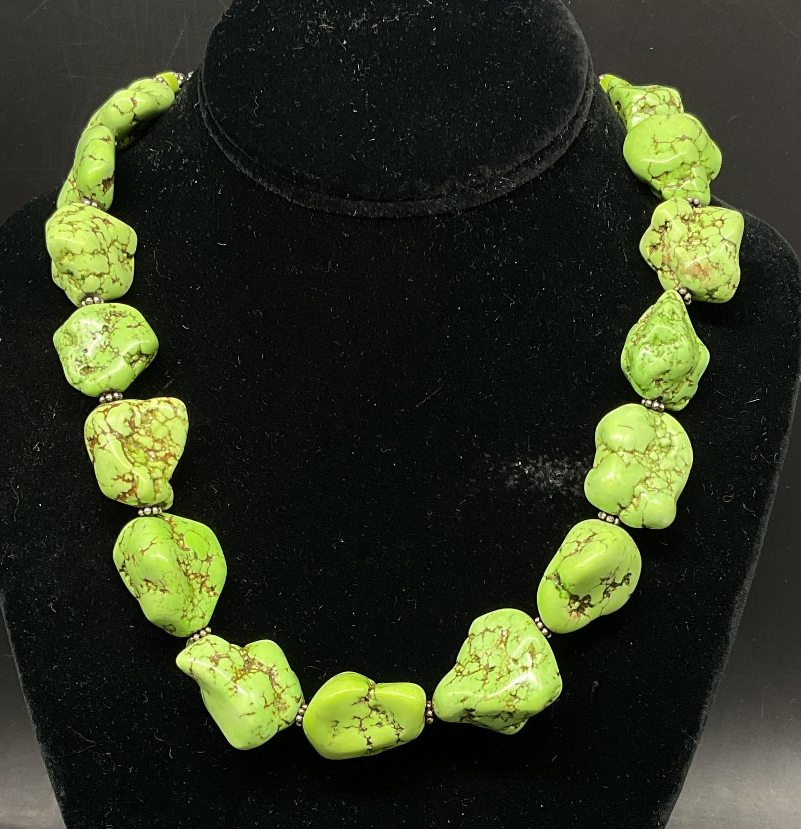 Large Tumbled Gaspeite Nugget & Sterling Necklace: Large Tumbled Green Mineral Nugget Necklace. Appears to be Gaspeite. Tested with Presidium Gem Tester II. No visible marks. Clasp tests as Sterling Silver with PuriTEST. Tarnishing present. Measures a