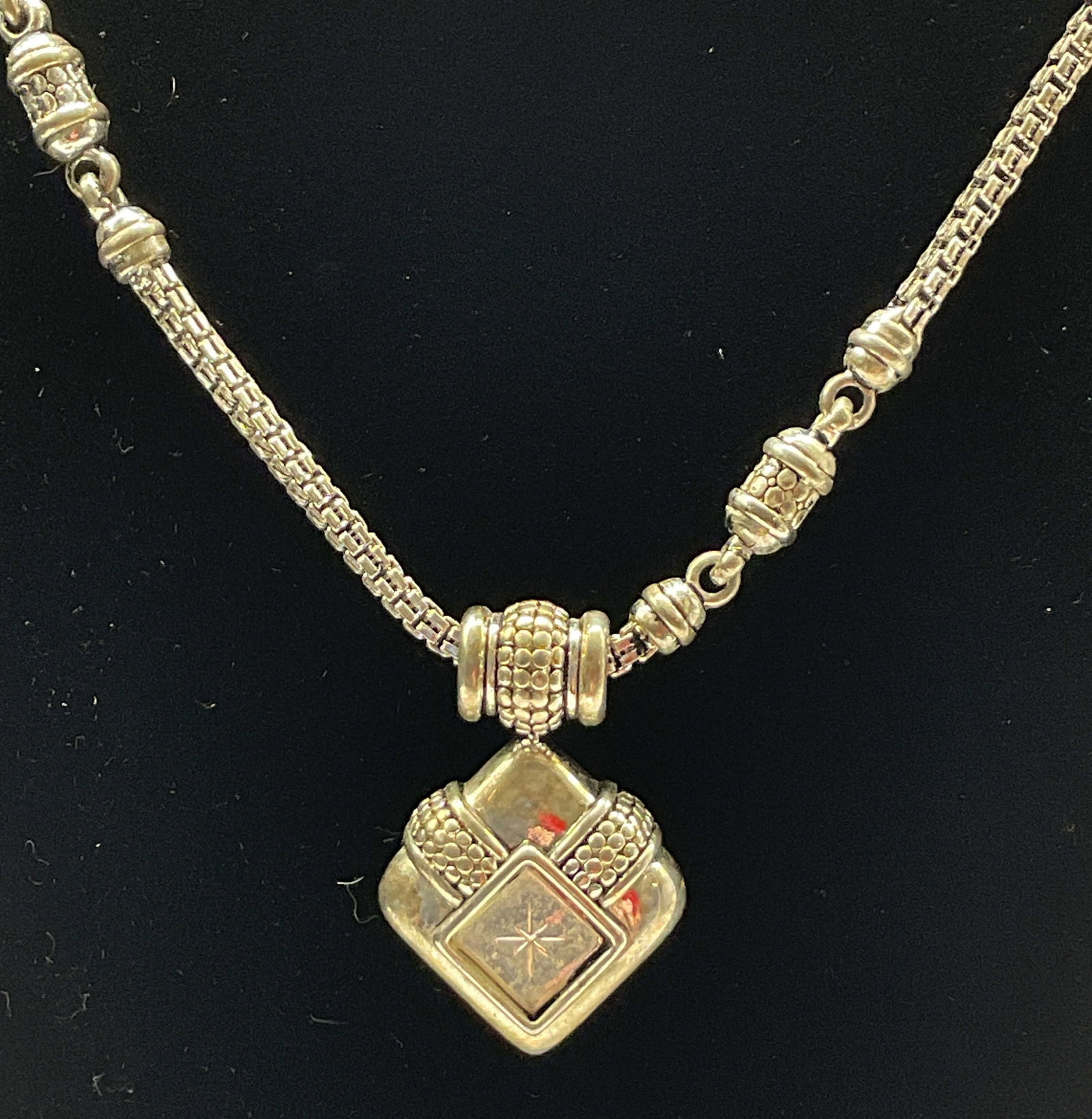Vintage Silver Toned Chain Pendant Necklace: Vintage silver toned chain pendant necklace. Chunky geometric pendant with textured detail. Ornate spacers. Measures approx 15 inches full length with additional 2 inches, adjustable. Scratching.