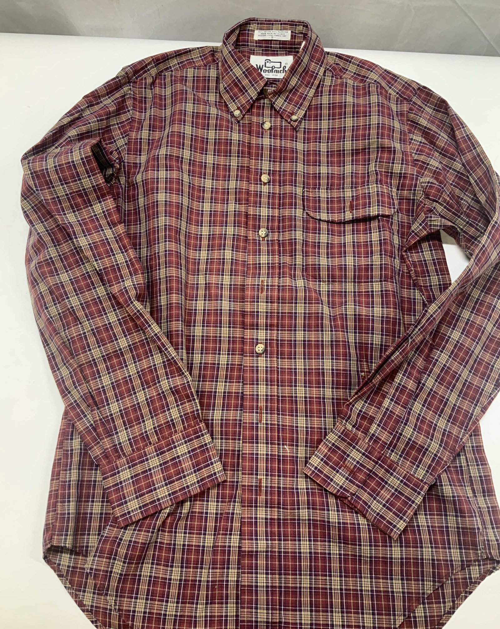 Vntg WOOLRICH plaid button down shirt: Vintage WOOLRICH plaid button down shirt. Made of a cotton polyester blend. Features a tartan plaid of burgundy with tan yellow and blue lines. No size listed, measures app 40 in chest and app 28 in