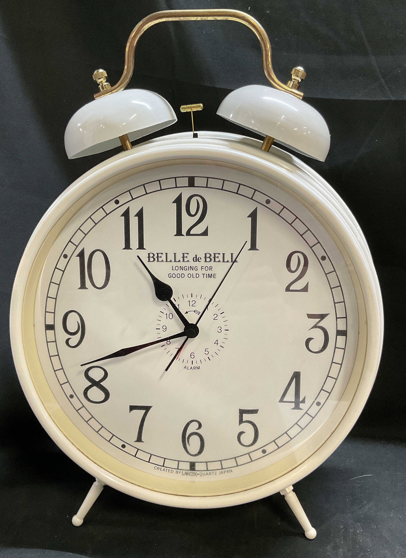 Belle de Bell Landex Twin-Bell Alarm Clock Japan: Oversized Vintage-Style Belle de Bell by Landex Twin-Bell Alarm Clock. Off-White Metal Body with Gold-Toned Handles. Japan. Battery-Operated Quartz Clock. Condition consistent with age and exposure.