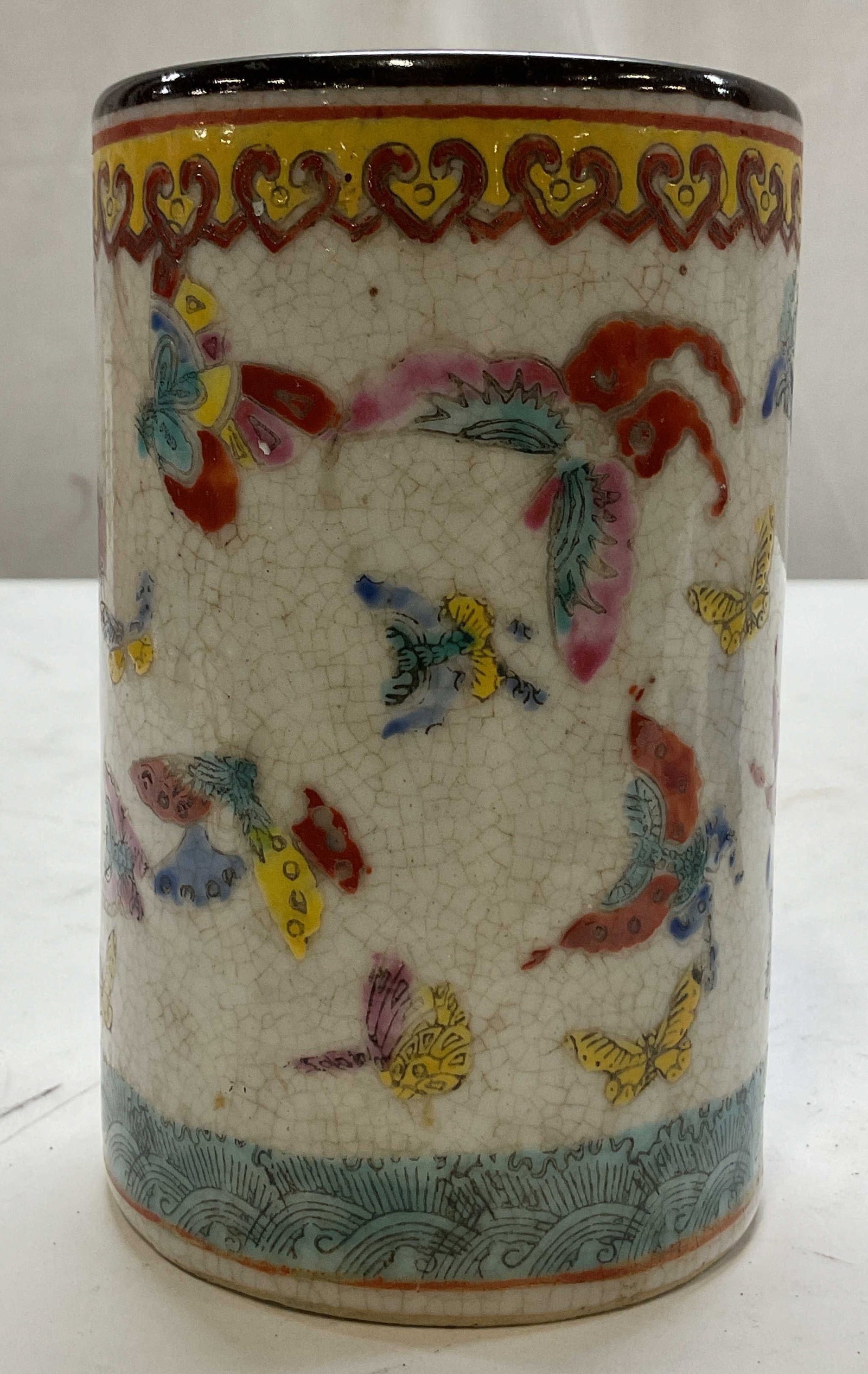 Vintage Chinese Famille Rose Porcelain Brush Pot: Vintage Chinese famille rose porcelain brush pot. Marked on underside. Cylindrical shape. Crackle glaze. Hand painted enamel butterfly and insect motifs. Decorative wave and scroll pattern. Varying