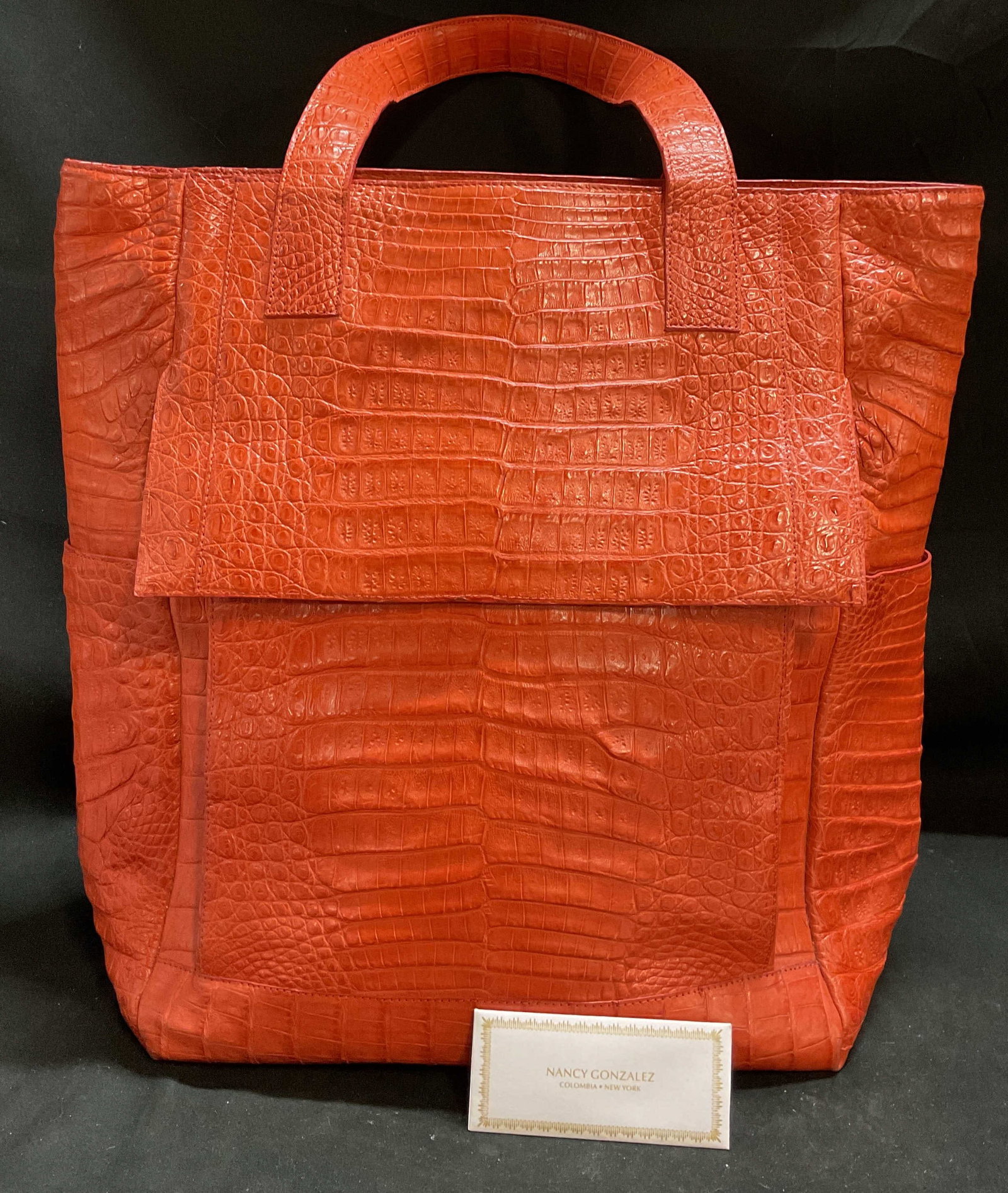 Nancy Gonzalez Gen Caiman Crocodile Tote Columbia: Nancy Gonzalez Genuine Caiman Crocodile Orange Leather Tote Bag. Columbia. Manufactured with authentic skins from breeding farms legally authorized by CITES. Suede interior. Some scuffing on bottom