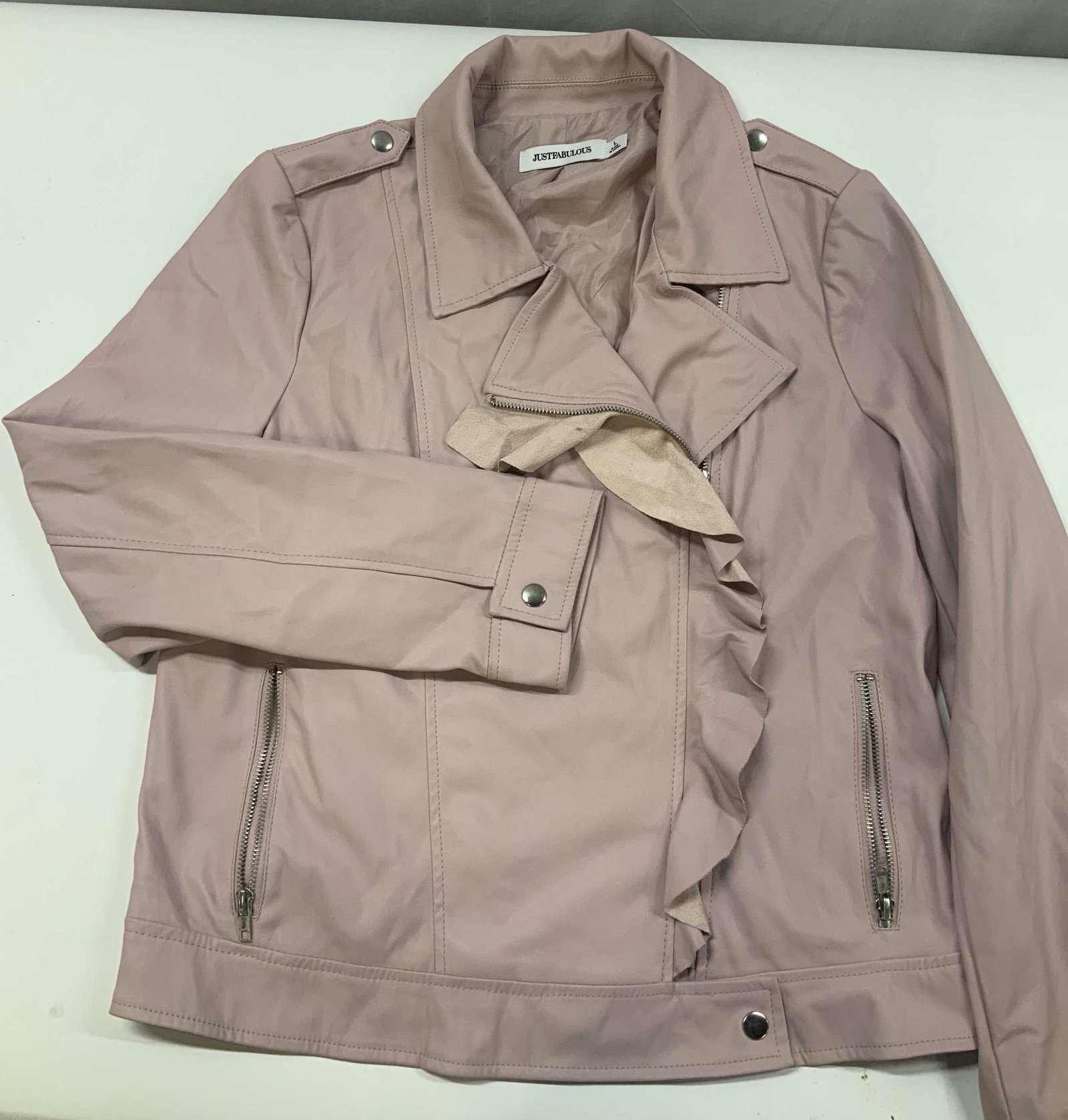 JustFab pink ruffle faux leather jacket: JustFab pink ruffle faux leather jacket. Tag says JUST FABULOUS, brand better known as JustFab. Made 100% polyester in size large. The standout features is the raw edged ruffle trim cascading down