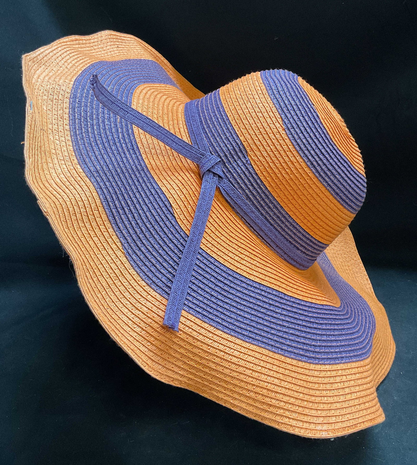 D&Y Purple & Orange Striped Floppy Sun Hat: D&Y Purple and Orange Striped Floppy Sun Hat. Purple string tie. Bendable rim. Reads one size fits most. Rim poking through slightly. D&Y, purple, orange, stripes, sun hat, floppy hat, beach,