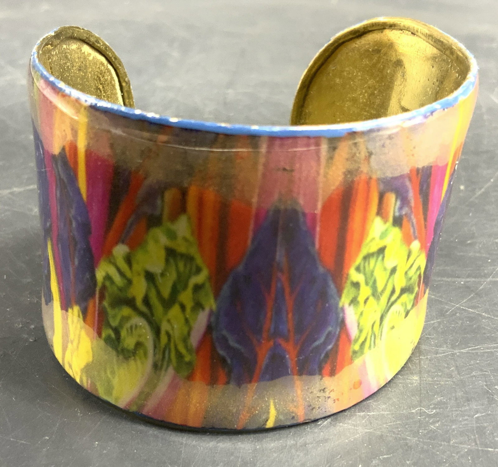 Multi Color painted Brass wide cuff Bracelet: Vintage wide open cuff brass bracelet featuring a vibrant multi colored abstract design on the exterior and a polished gold tone interior, measured width 2 inches, bracelet a cross 2.5 inches, smooth