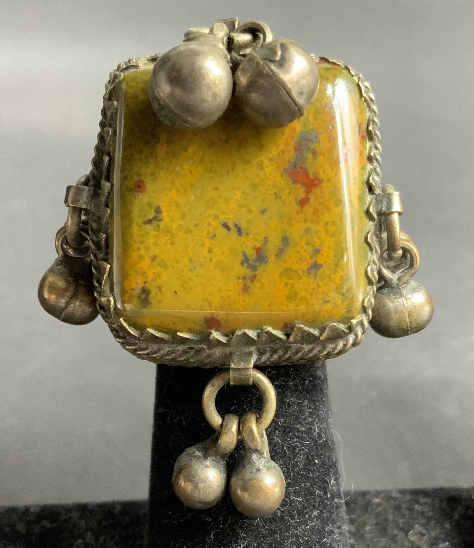 Vntg Amulet Silver Stone Bead Ring: Antique or vintage Amulet Box Like Ring, Gau Ring, featuring a large yellow green toned polished natural stone cabochon set in ornate silver and brass toned wire frame, and dangling spherical beads ,
