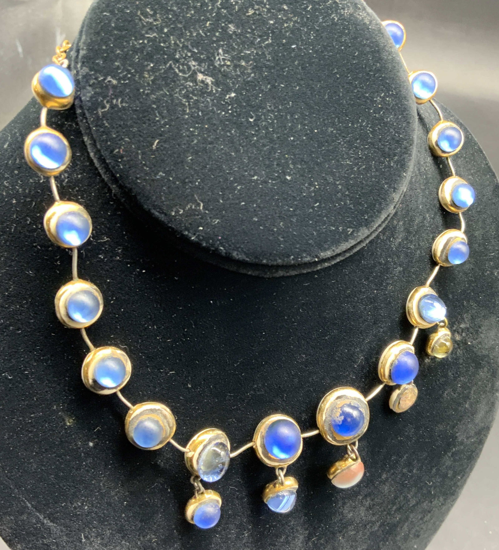 Signed Moonstone Fringe Dropper Necklace: Signed in gold cursive back of center drop, DG, Antique style moonstone fringe dropper necklace featuring graduated cabochon moonstone set in a gilded and silver tone chain, drop length measures app