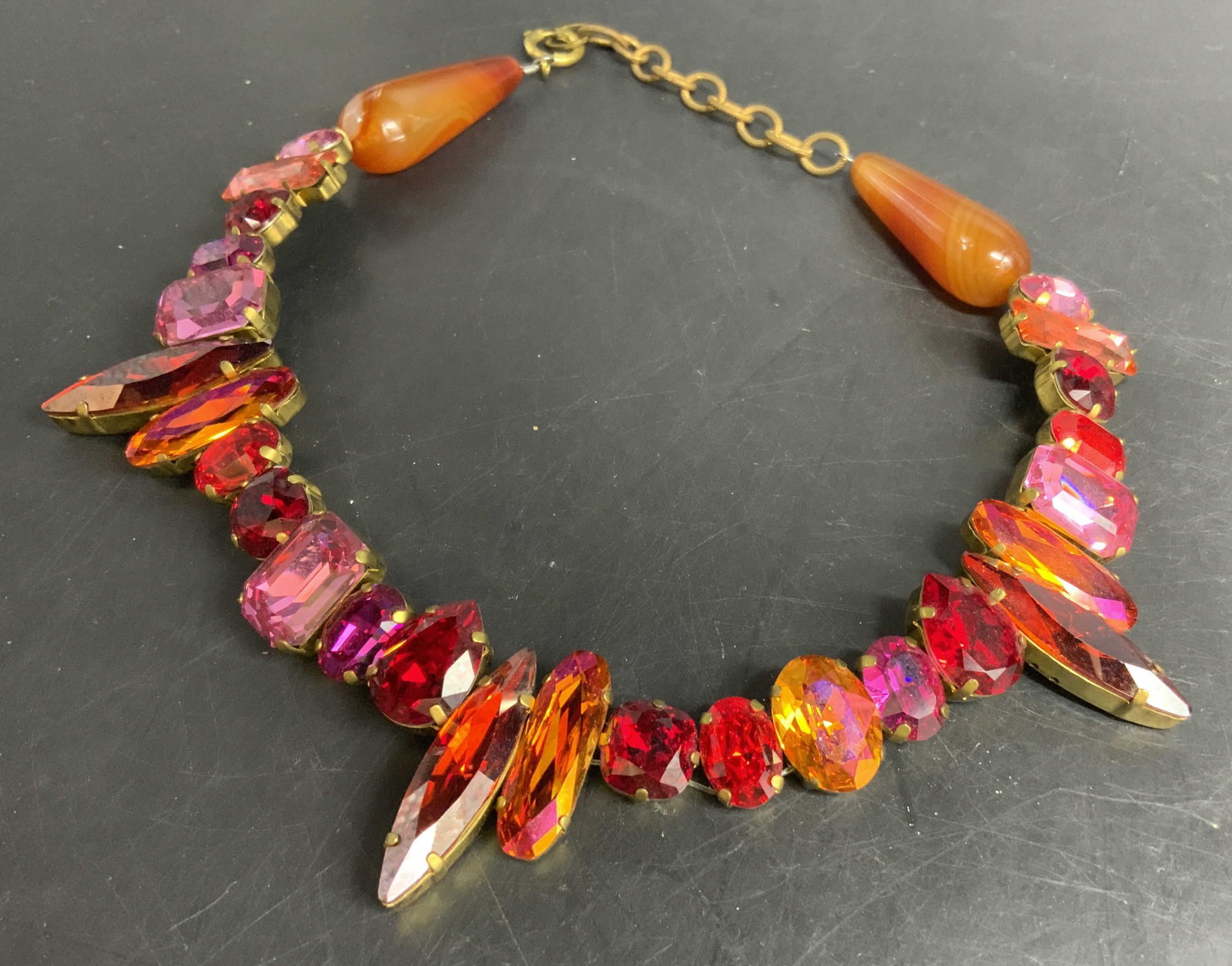 Crystal Rhinestone Pink Orange Statement Necklace: Vintage statement necklace, adjustable length, features rhinestones in bold mismatched geometric cuts, in brass settings and brass chain, mix of sunset tones including magenta, Ruby red, hot pink,