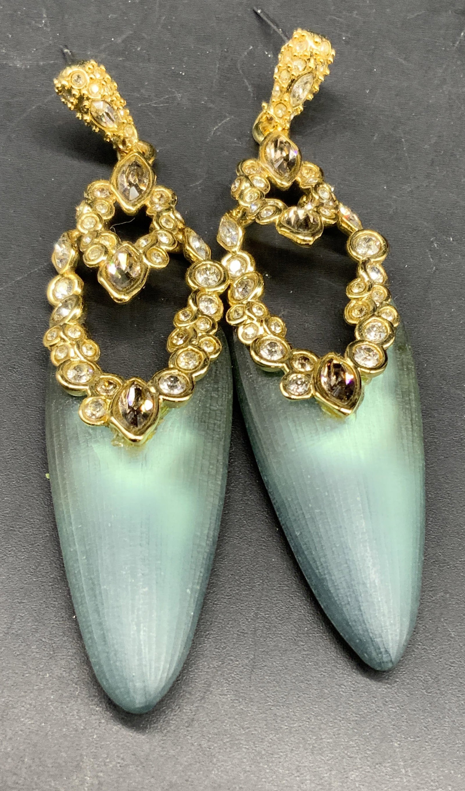 Alexis Bittar Sgnd Lucite Crystal Drop earrings: Gold plated Alexis Bittar Drop Earrings features a sculpted glowing gray green lucite drop with ornate gold plated metal work and multi size set circular crystals around oval ang drop dangle, and crys
