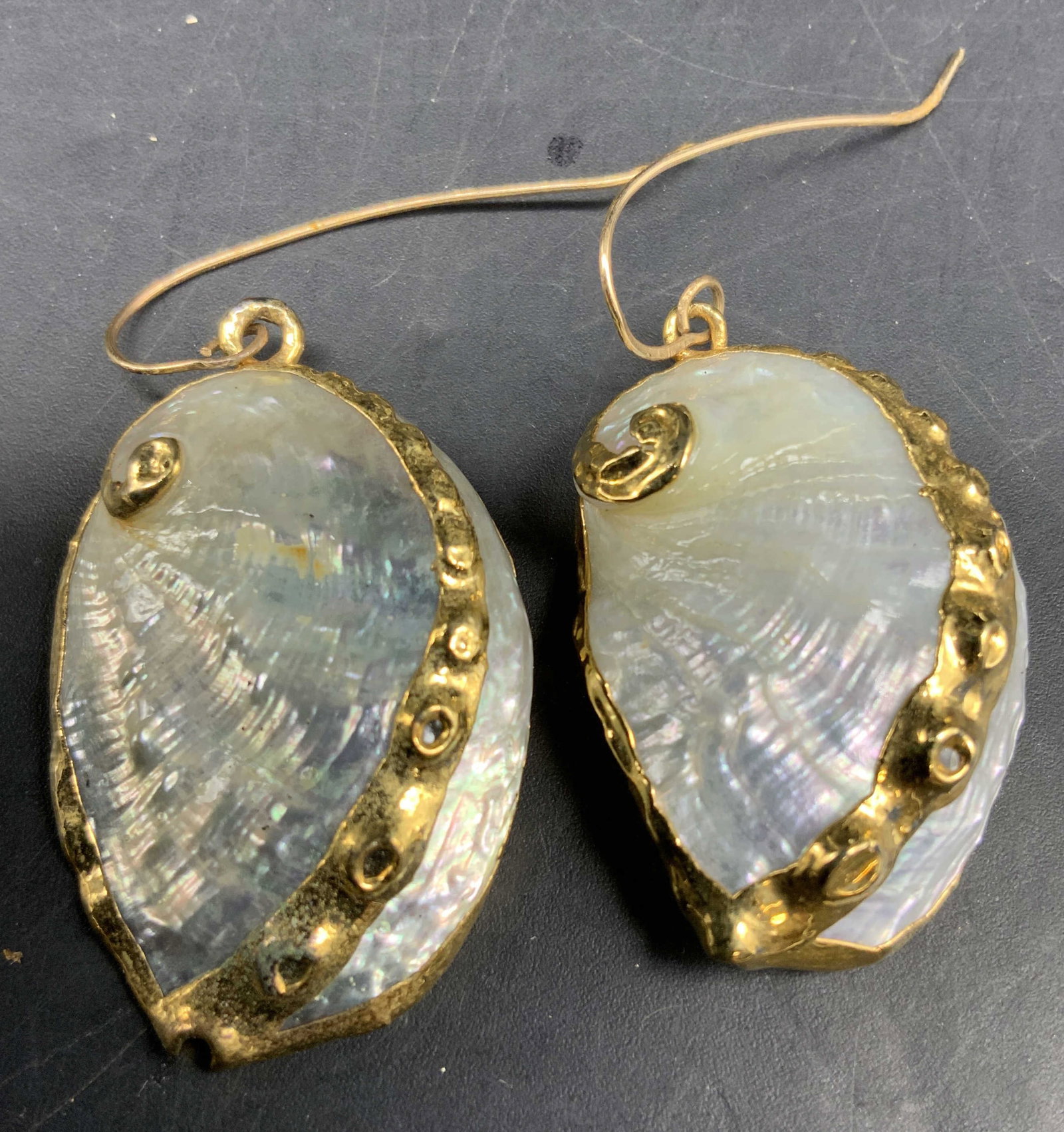 Pr of Gold Plated mother-of-pearl Drop earrings: Attributed to SIMAN Tu, hand crafted natural mother of pearl earrings in spiral snail design with iridescent pearlescent centers and gold plated gold foil wrapped edges and spiral accent, each measure