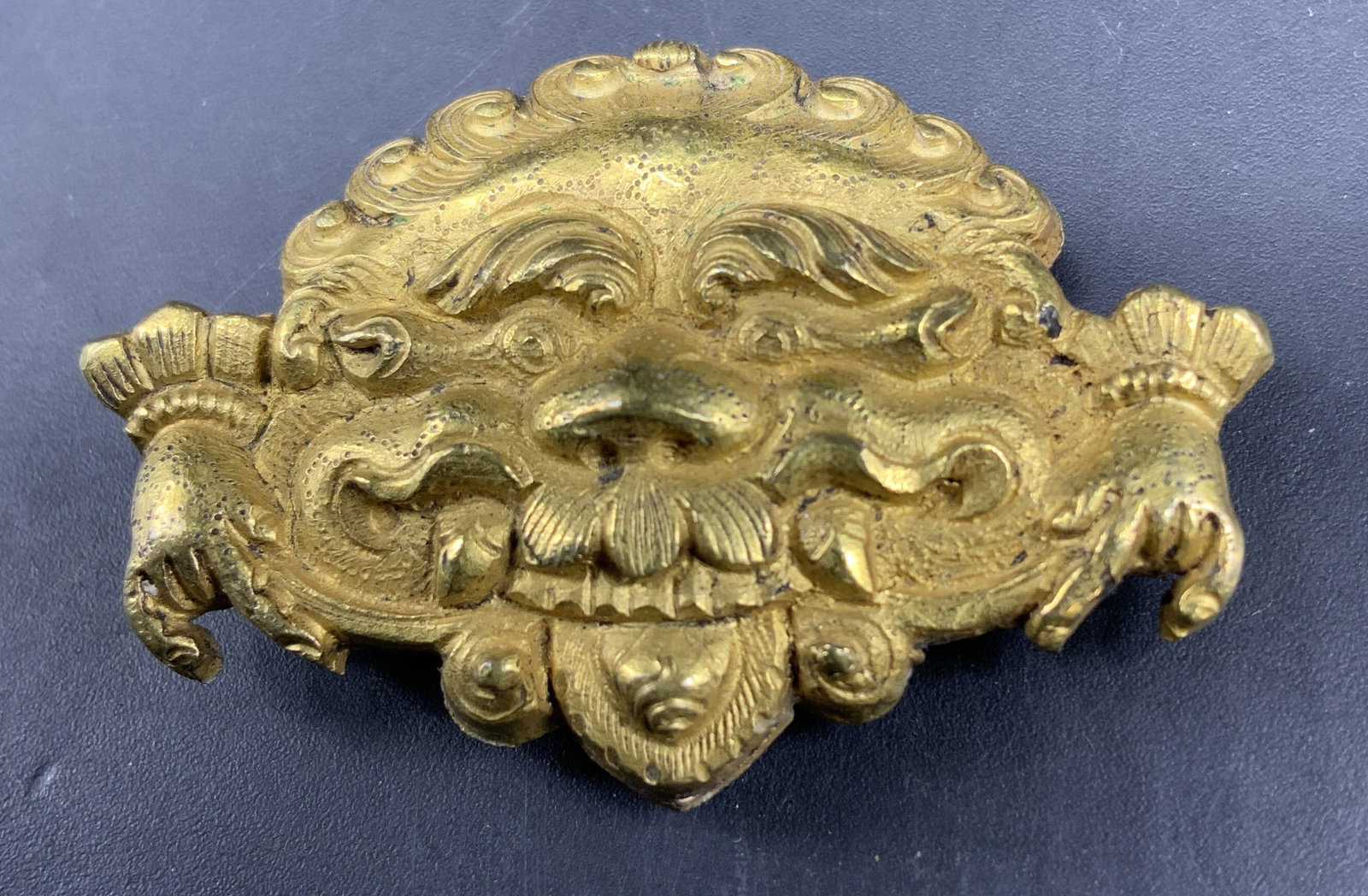 Vntg Gold Toned Kirtimukha Mythical Face Brooch: Gilt brooch of Kirtimukha , face of glory, mythological monster with wide eyed facial expression curly hair and crown elements , Buddhist and Himalayan guardian figure, possibly cast bronze and