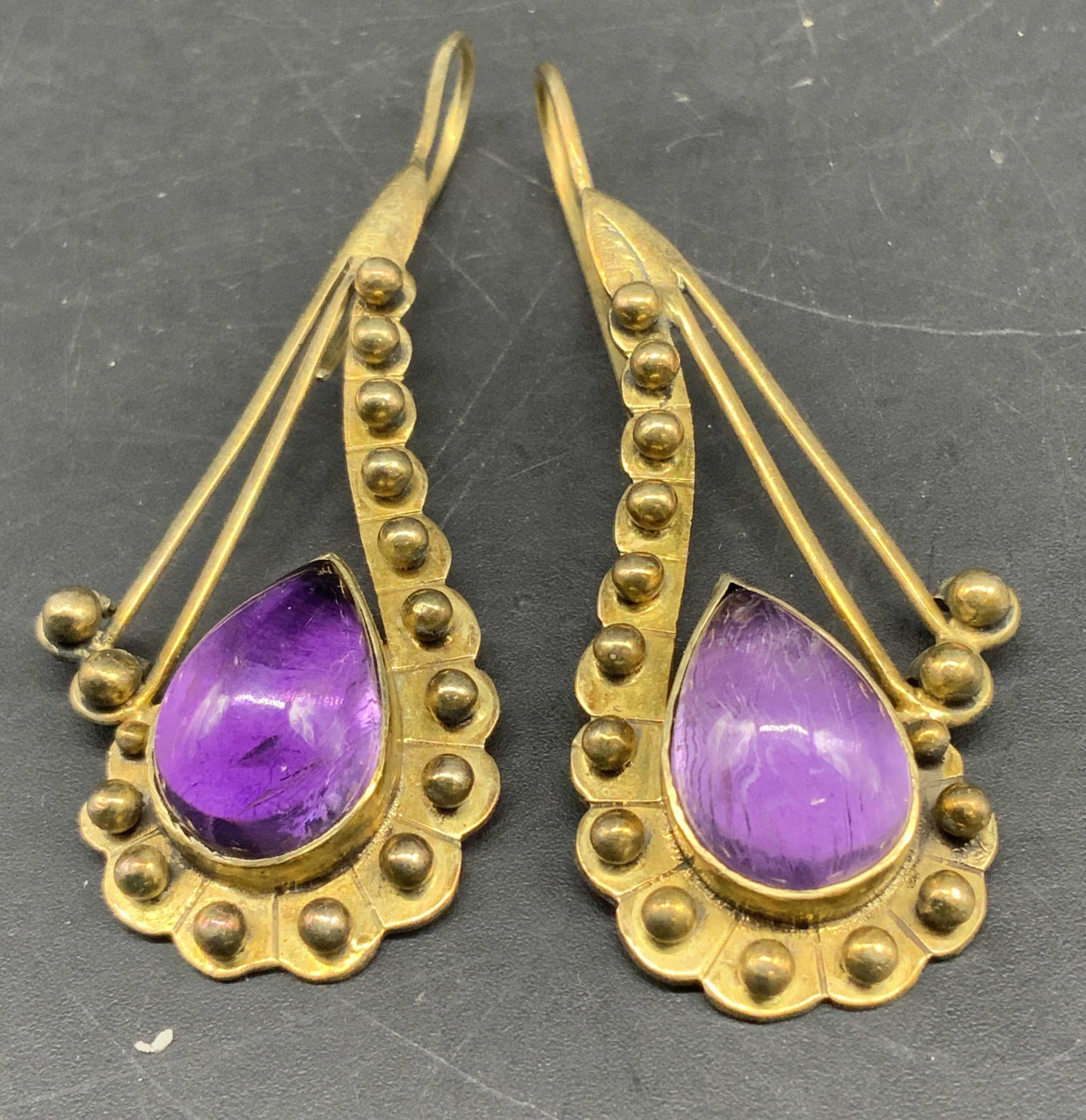 Sterling Amethyst Etruscan Revival Earrings: Gold over sterling drop earrings, vibrant bezel set polished Amethyst cabochons cut into distinctive pear or teardrop shapes, intricate gold over sterling silver metal work detailing with granulation 