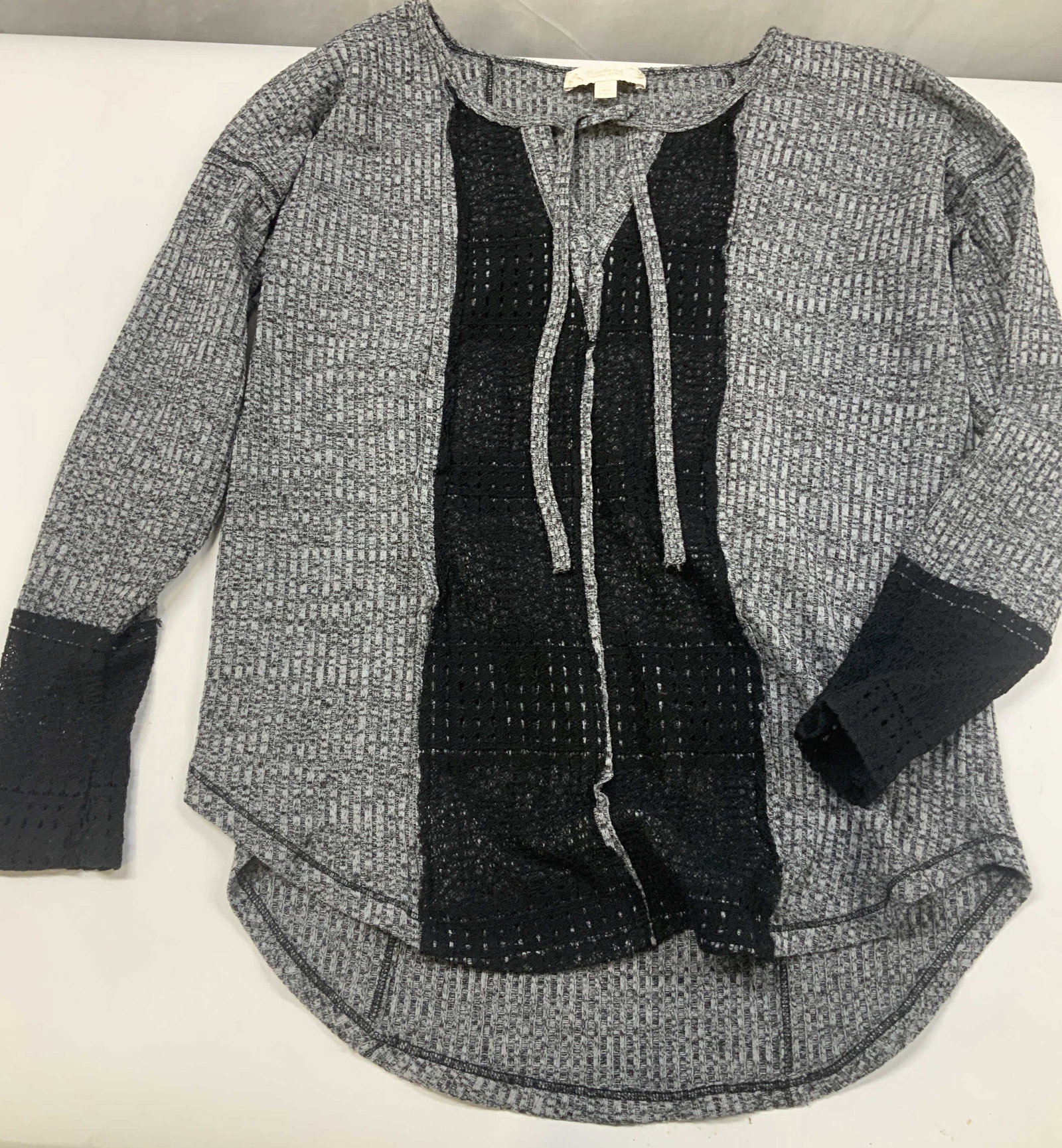 WEEKEND by Suzanne Betro grey knit and lace top: WEEKEND by Suzanne Betro grey knit and lace top. It features vertical accent panels of black lace running down the center front and on the sleeve cuffs. Features a relaxed split v neck neckline with