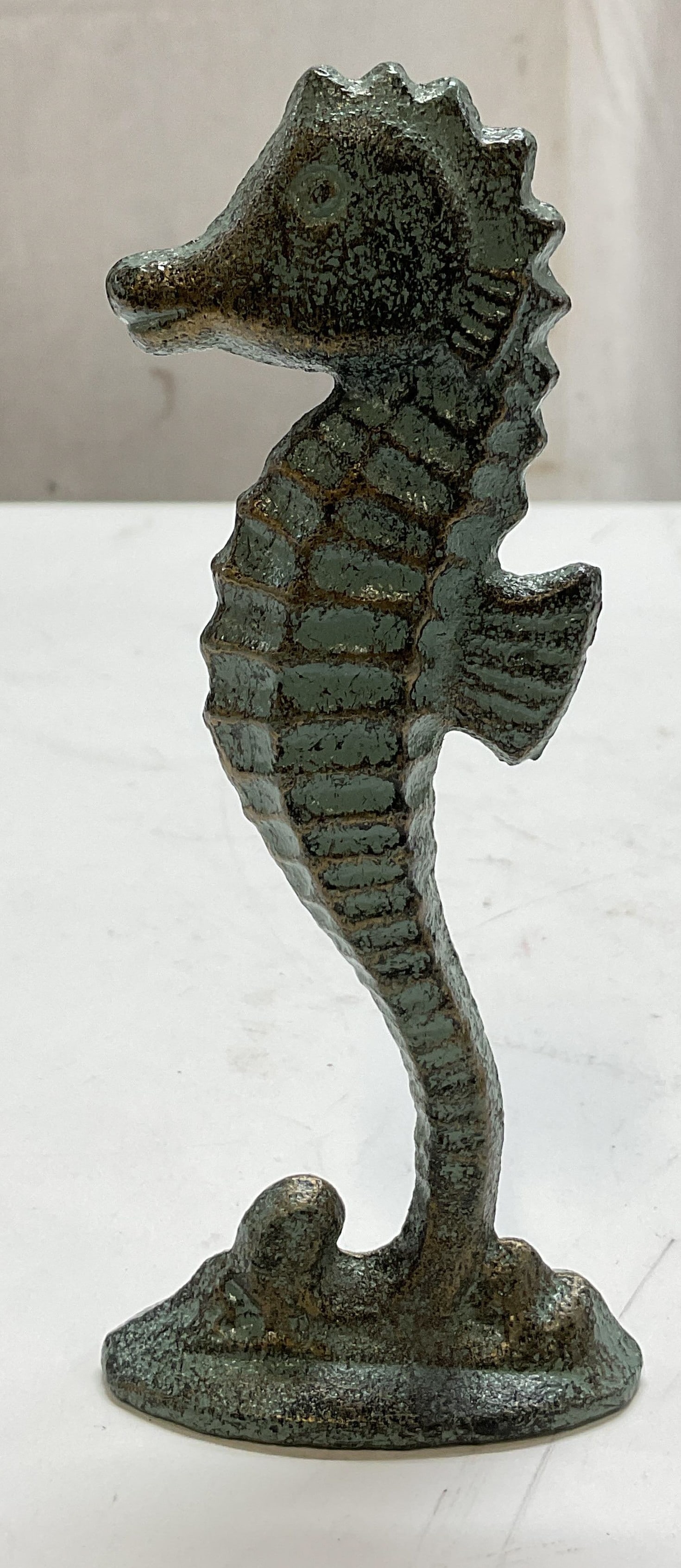 Vintage Cast Iron Seahorse Figure: Vintage cast iron seahorse figure. Oval shaped base. Detailed features and textures. Painted finish, designed to look like bronze verdigris patina. Gilt accents. Measures ht approx 5.5 inches diam